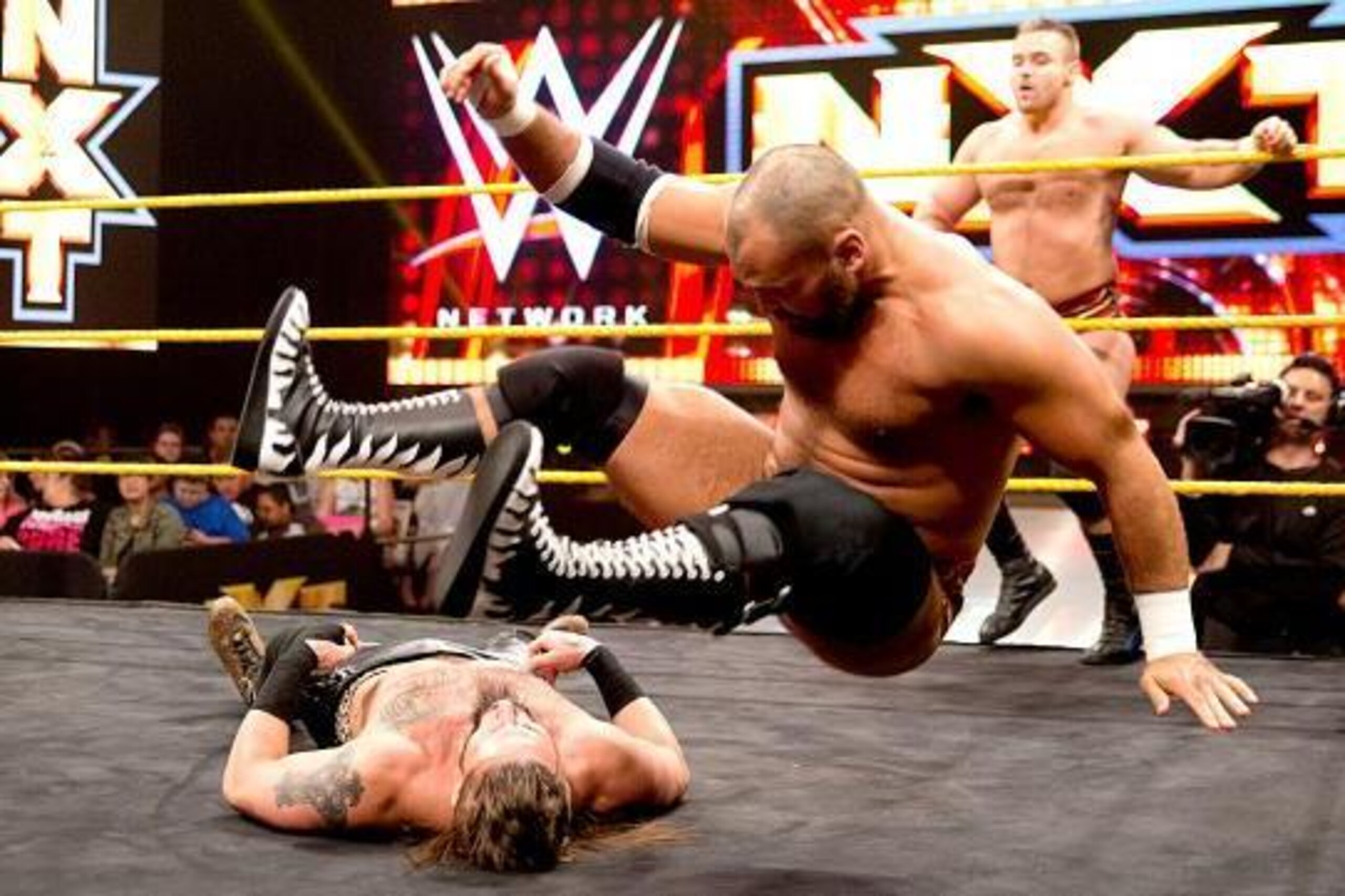 Scott Dawson hits a leg drop on Enzo Amore.