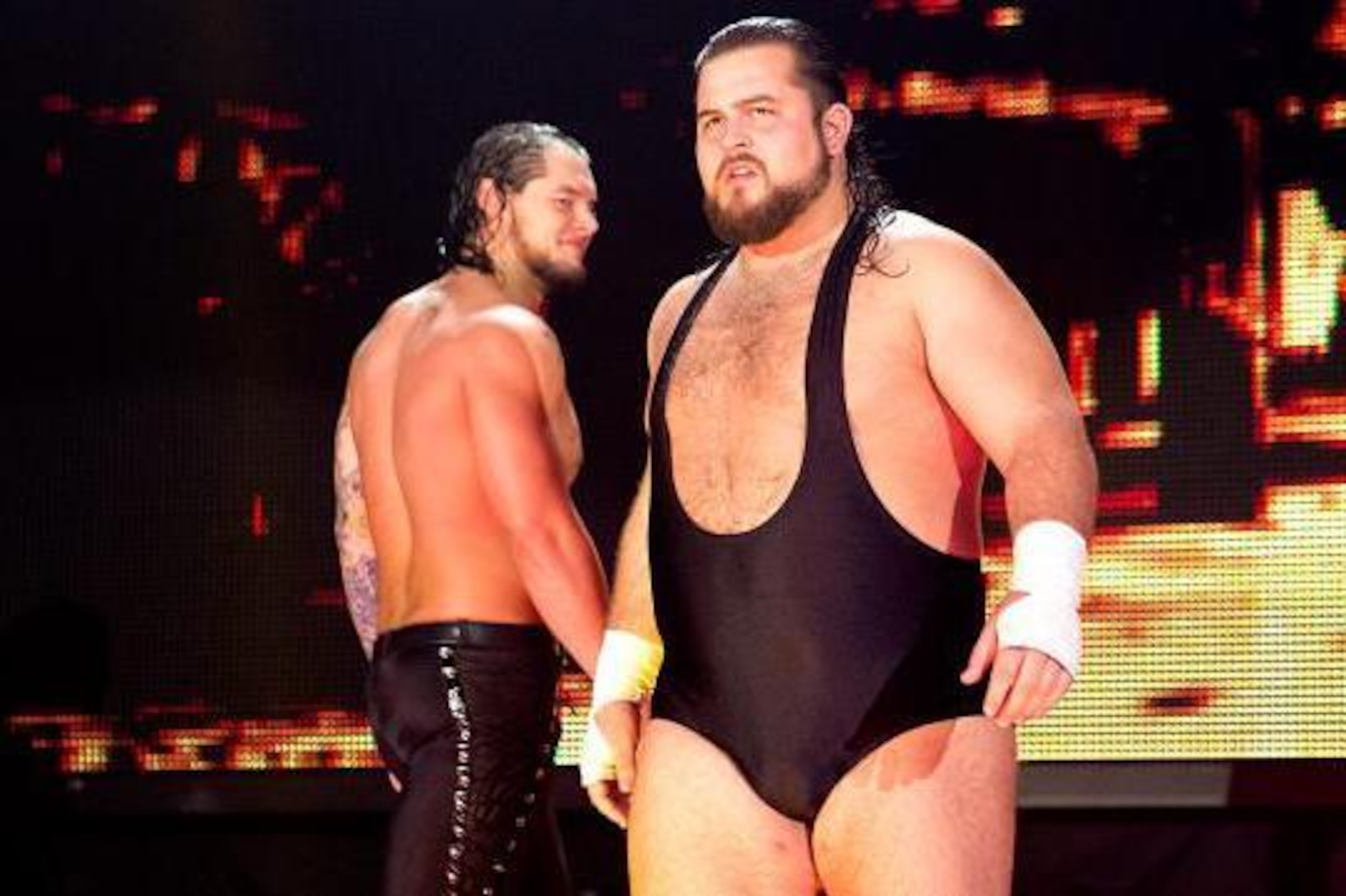 Baron Corbin walks by Bull Dempsey.