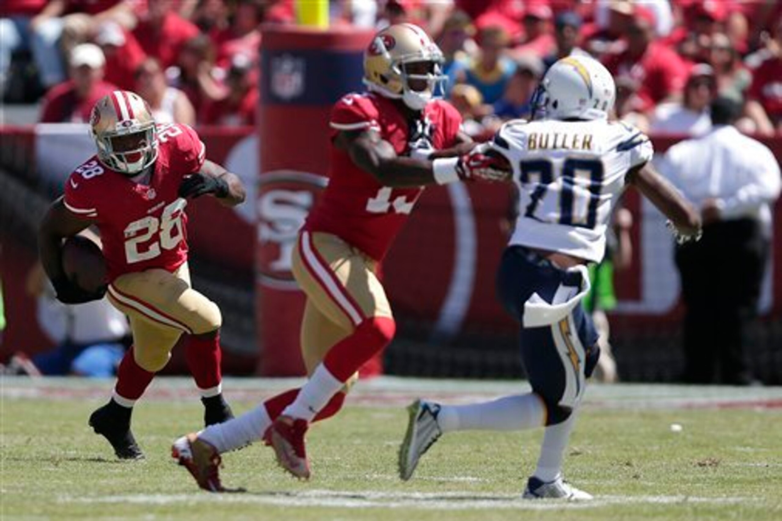 Stevie Johnson (No. 13) helps pave the way for Carlos Hyde (No. 26) in preseason action against the San Diego Chargers.