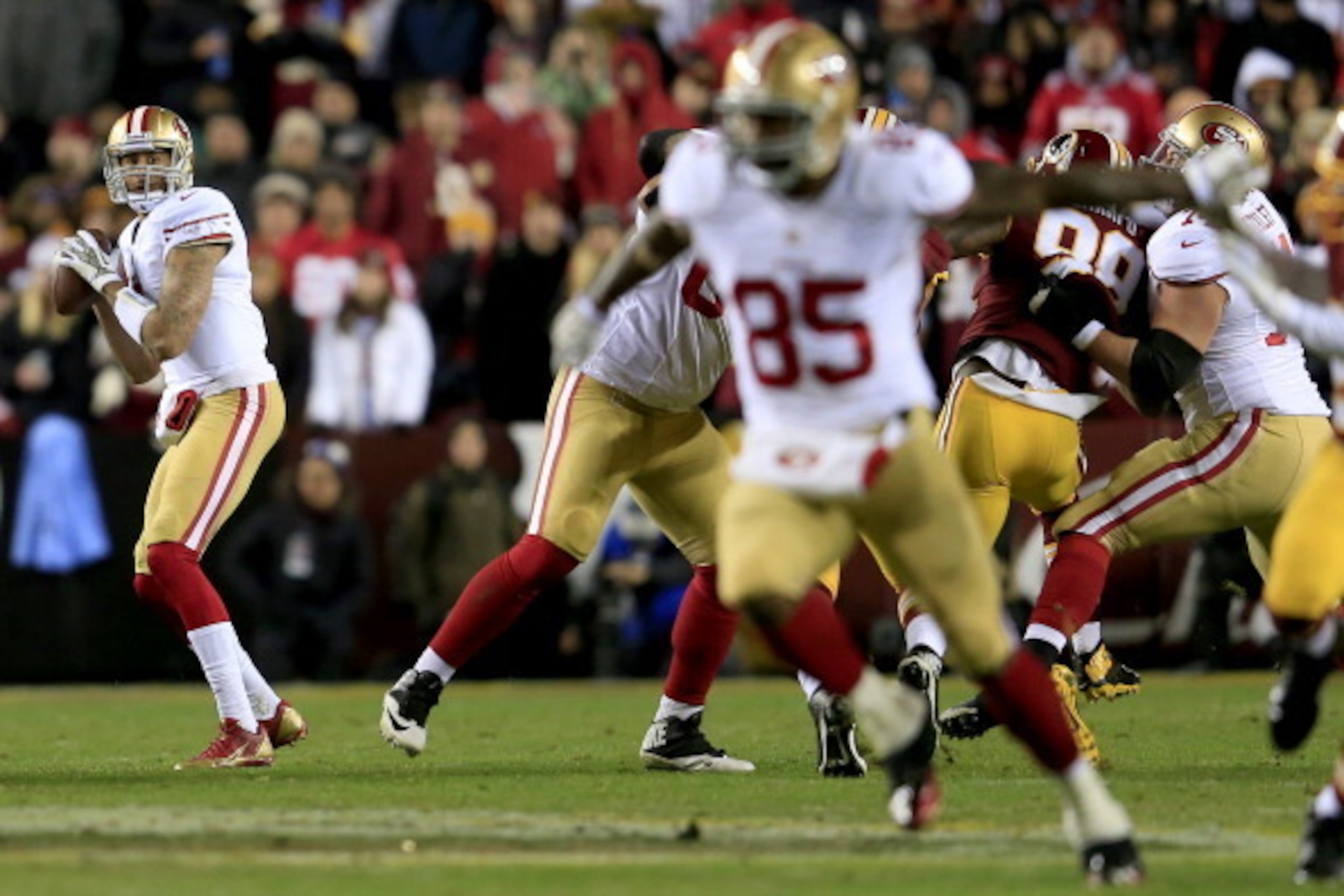 LANDOVER, MD - NOVEMBER 25:  Quarterback Colin Kaepernick #7 of the San Francisco 49ers looks to pass to tight end Vernon Davis #85 in the first half agaisnt the Washington Redskins at FedExField on November 25, 2013 in Landover, Maryland.  (Photo by Rob 