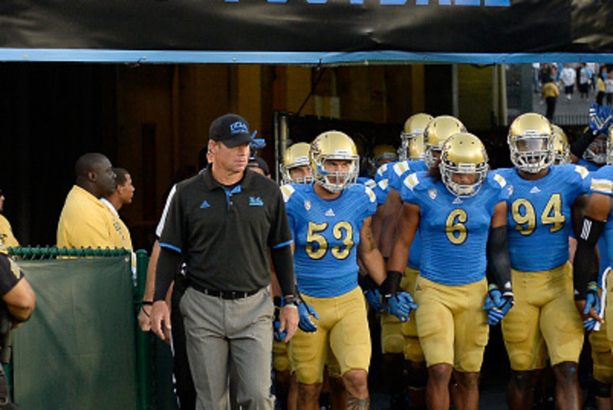 PASADENA, CA - SEPTEMBER 06:  Head coach Jim Mora of the UCLA Bruins leads his team onto the field for their season opening game against the Memphis Tigers at Rose Bowl on September 6, 2014 in Pasadena, California.  (Photo by Harry How/Getty Images)