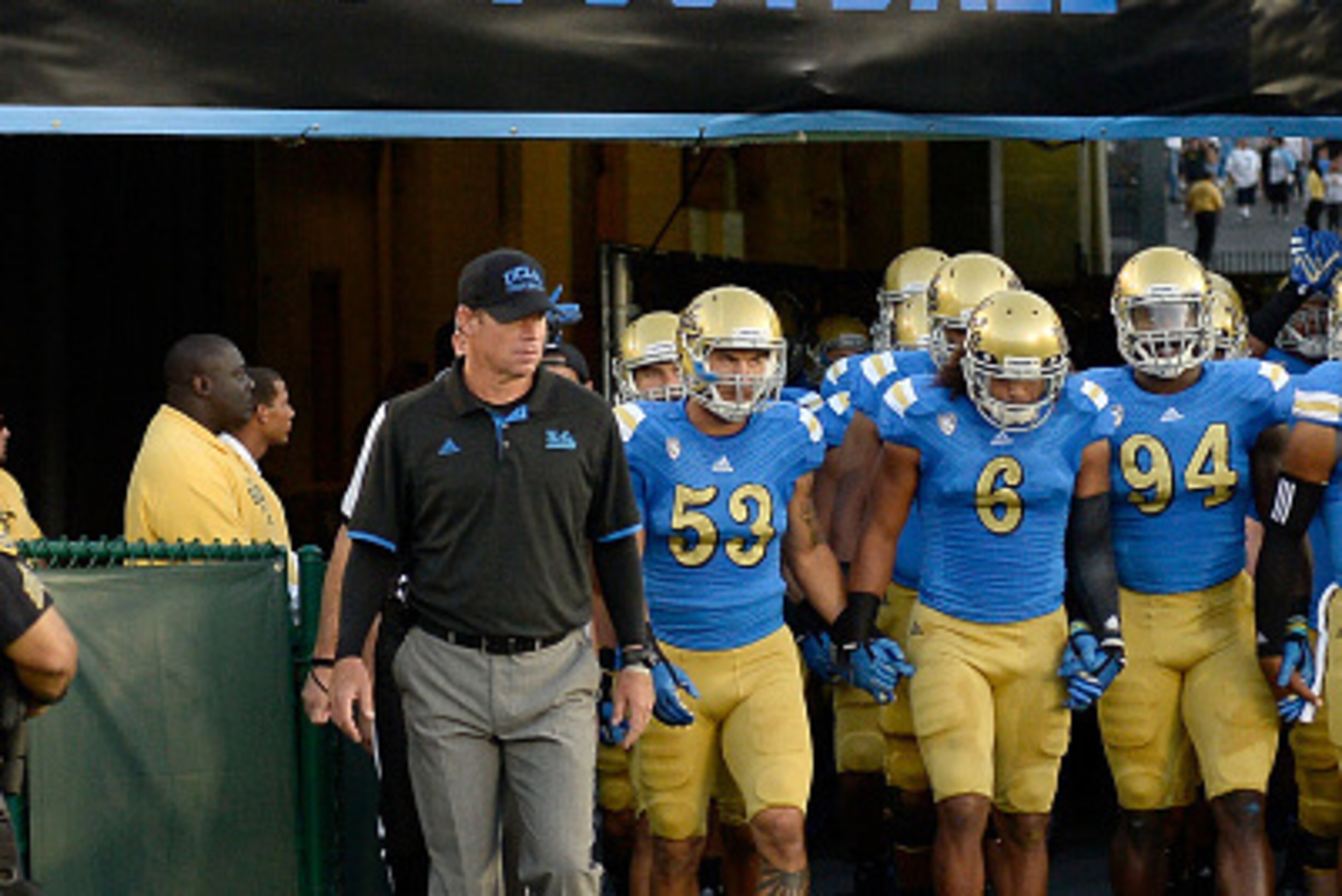 PASADENA, CA - SEPTEMBER 06:  Head coach Jim Mora of the UCLA Bruins leads his team onto the field for their season opening game against the Memphis Tigers at Rose Bowl on September 6, 2014 in Pasadena, California.  (Photo by Harry How/Getty Images)