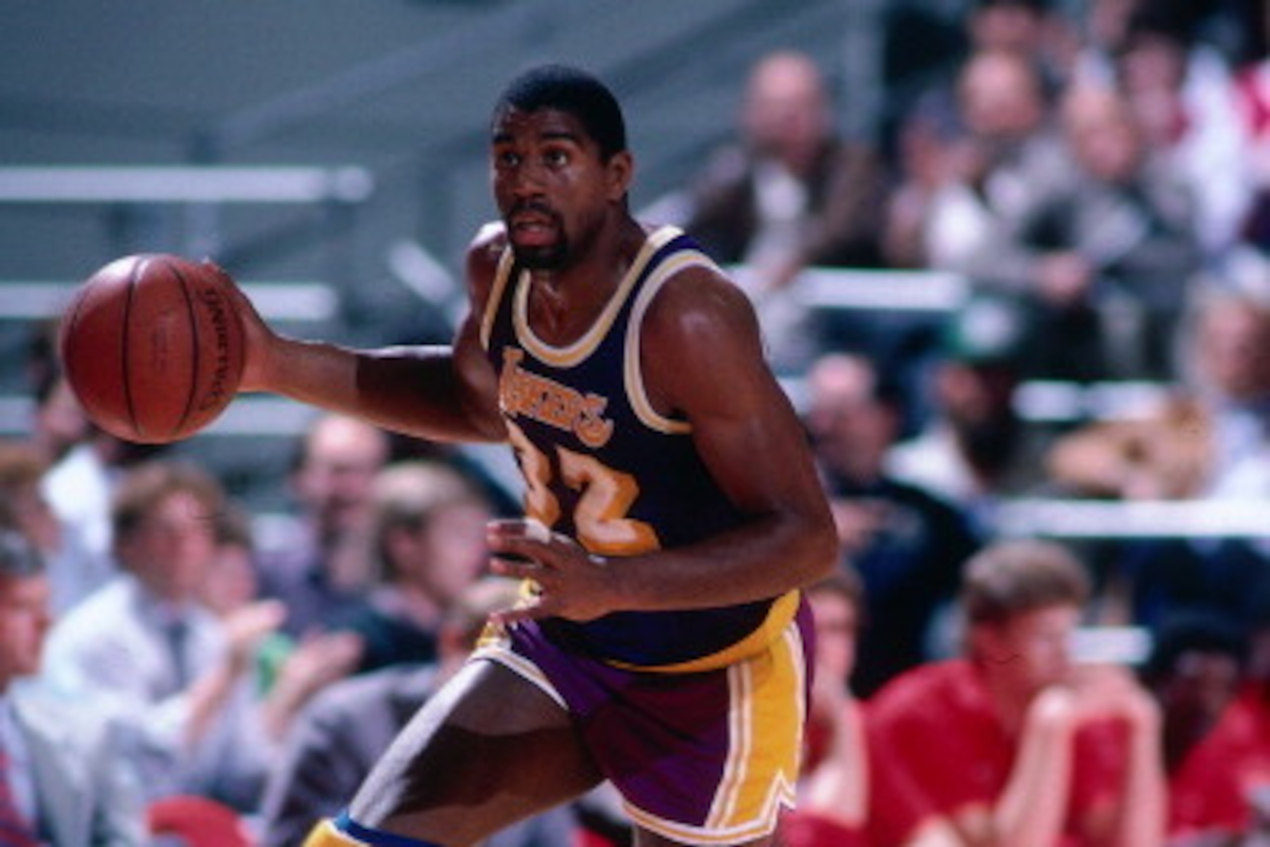 PORTLAND, OR - 1988: Magic Johnson #32 of the Los Angeles Lakers dribbles the ball against the Portland Trail Blazers   during a game played circa 1987 at the Veterans Memorial Coliseum in Portland, Oregon. NOTE TO USER: User expressly acknowledges and ag