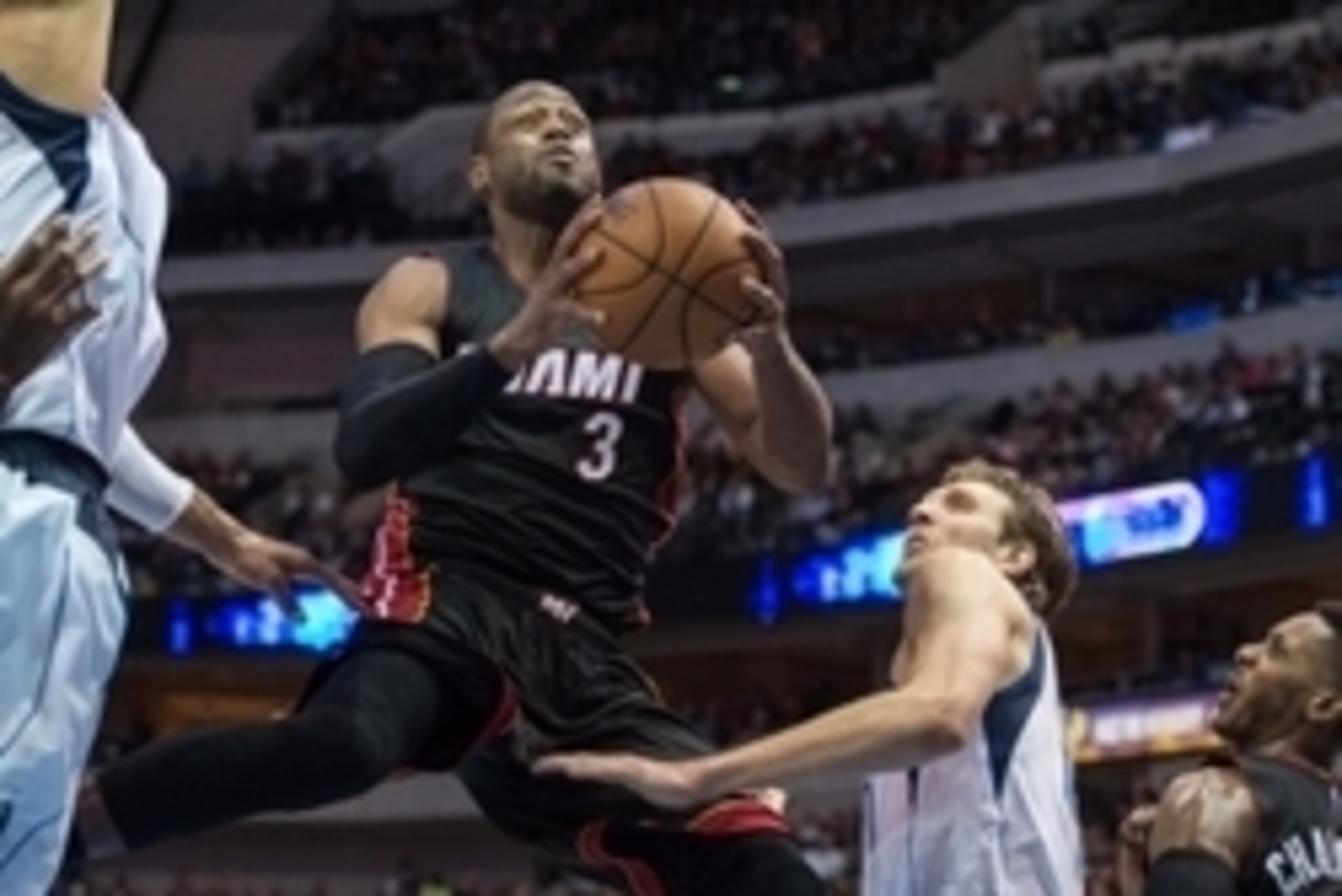 Nov 9, 2014; Dallas, TX, USA; Miami Heat guard Dwyane Wade (3) drives to the basket past Dallas Mavericks forward Dirk Nowitzki (41) during the second half at the American Airlines Center. The Heat defeated the Mavericks 105-96. Mandatory Credit: Jerome M