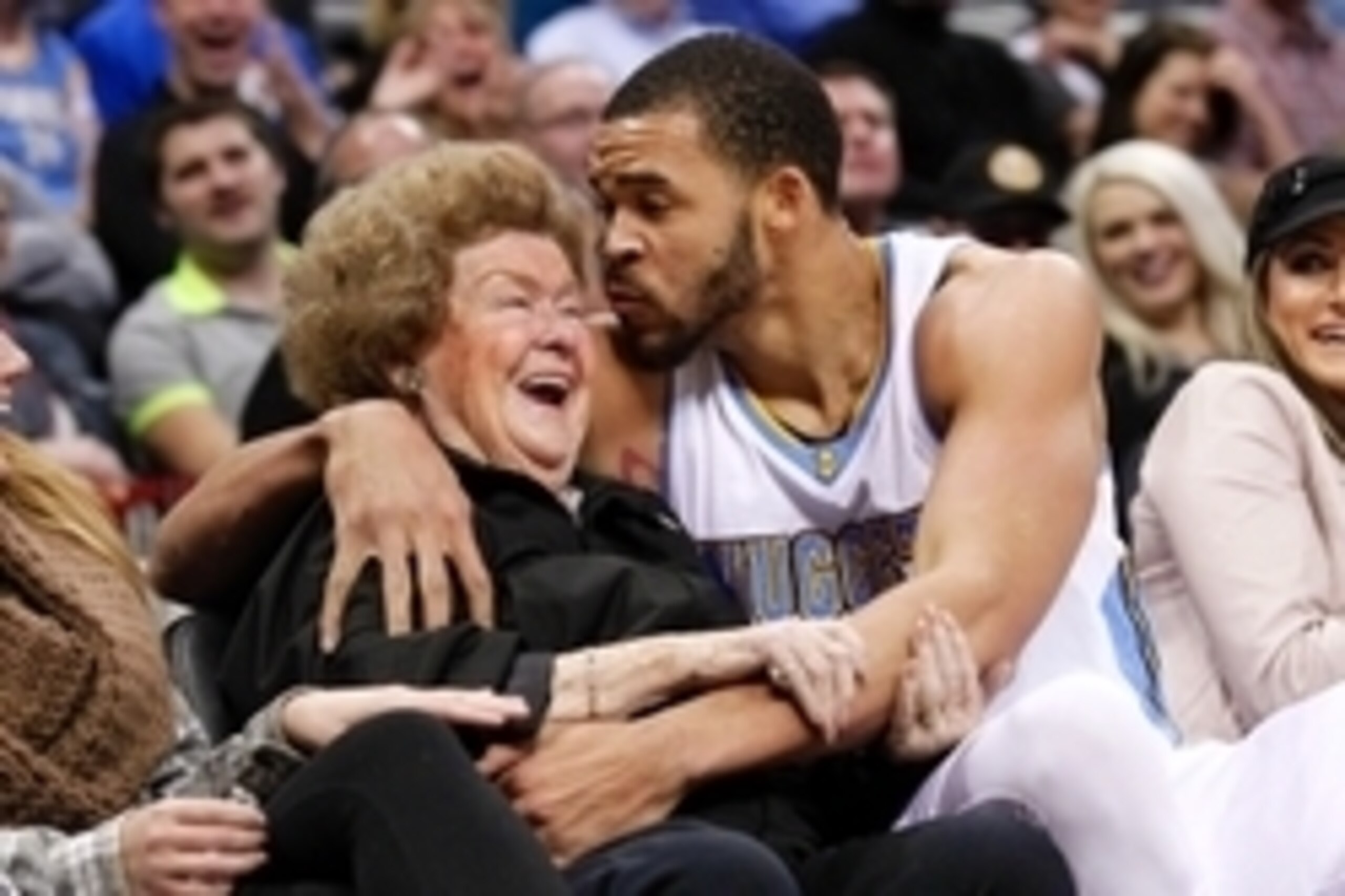 Nov 21, 2014; Denver, CO, USA; Denver Nuggets center JaVale McGee (34) kisses the cheek of Marilyn Quagliano after falling into an open seat next to her in the second quarter against the New Orleans Pelicans at Pepsi Center. Mandatory Credit: Isaiah J. Do
