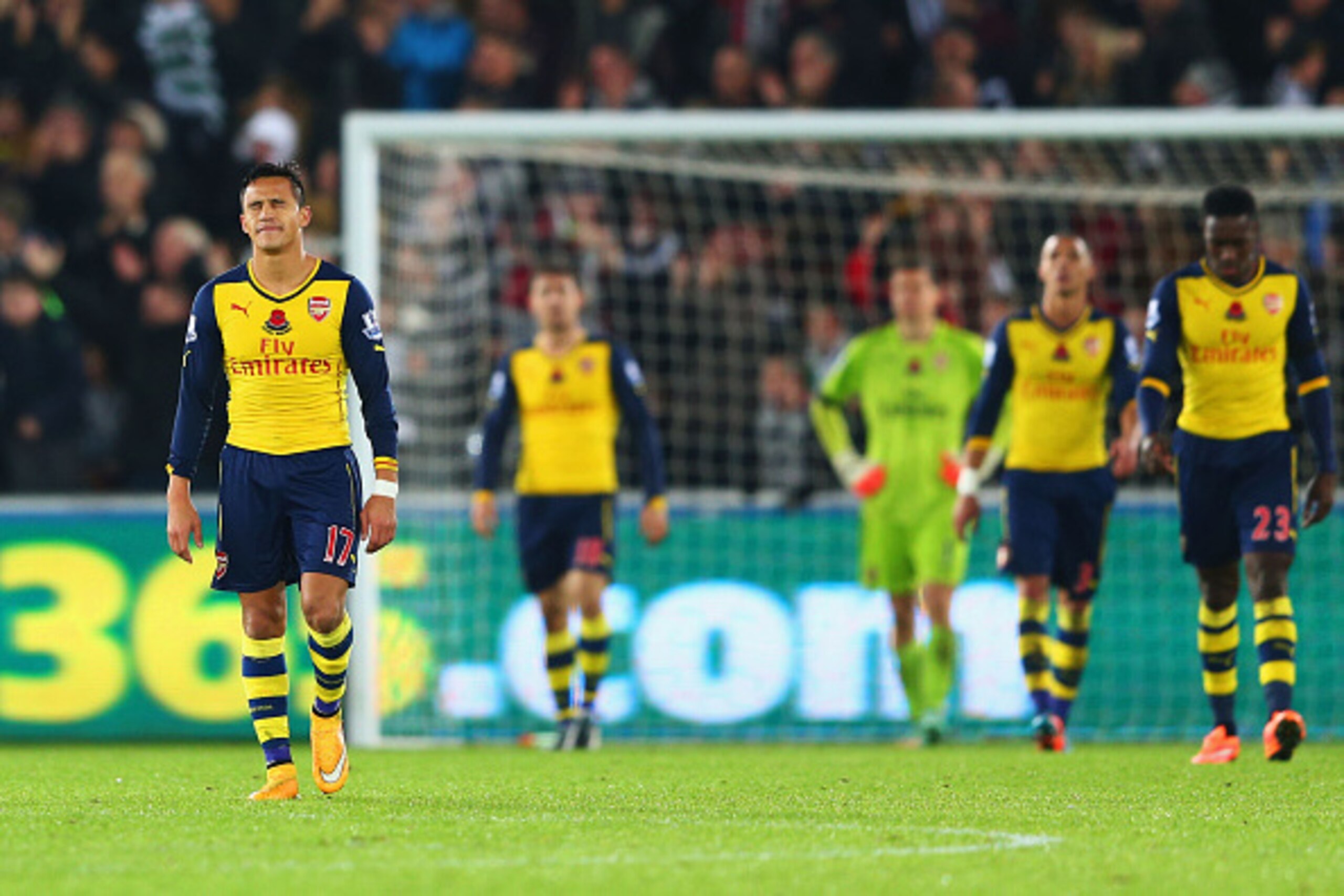 SWANSEA, WALES - NOVEMBER 09:  Alexis Sanchez of Arsenal (L) and team mates look dejected as they concede a goal during the Barclays Premier League match between Swansea City and Arsenal at Liberty Stadium on November 9, 2014 in Swansea, Wales.  (Photo by
