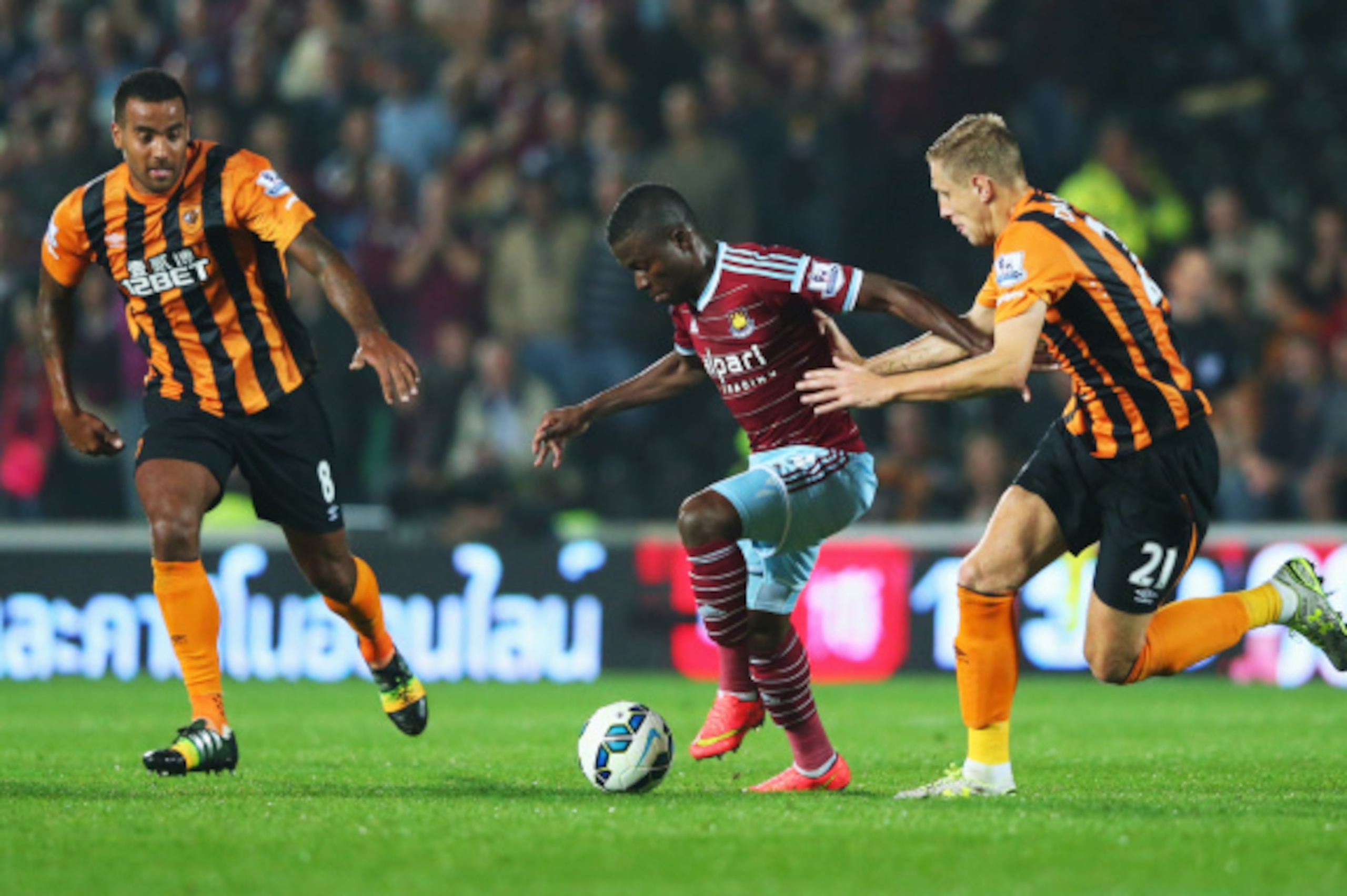 HULL, ENGLAND - SEPTEMBER 15: Enner Valencia of West Ham United goes between Tom Huddlestone (8) and Michael Dawson (21) of Hull City during Barclays Premier League match between Hull City and West Ham United at KC Stadium on September 15, 2014 in Hull, HULL, ENGLAND - SEPTEMBER 15: Enner Valencia of West Ham United goes between Tom Huddlestone (8) and Michael Dawson (21) of Hull City during Barclays Premier League match between Hull City and West Ham United at KC Stadium on September 15, 2014 in Hull,