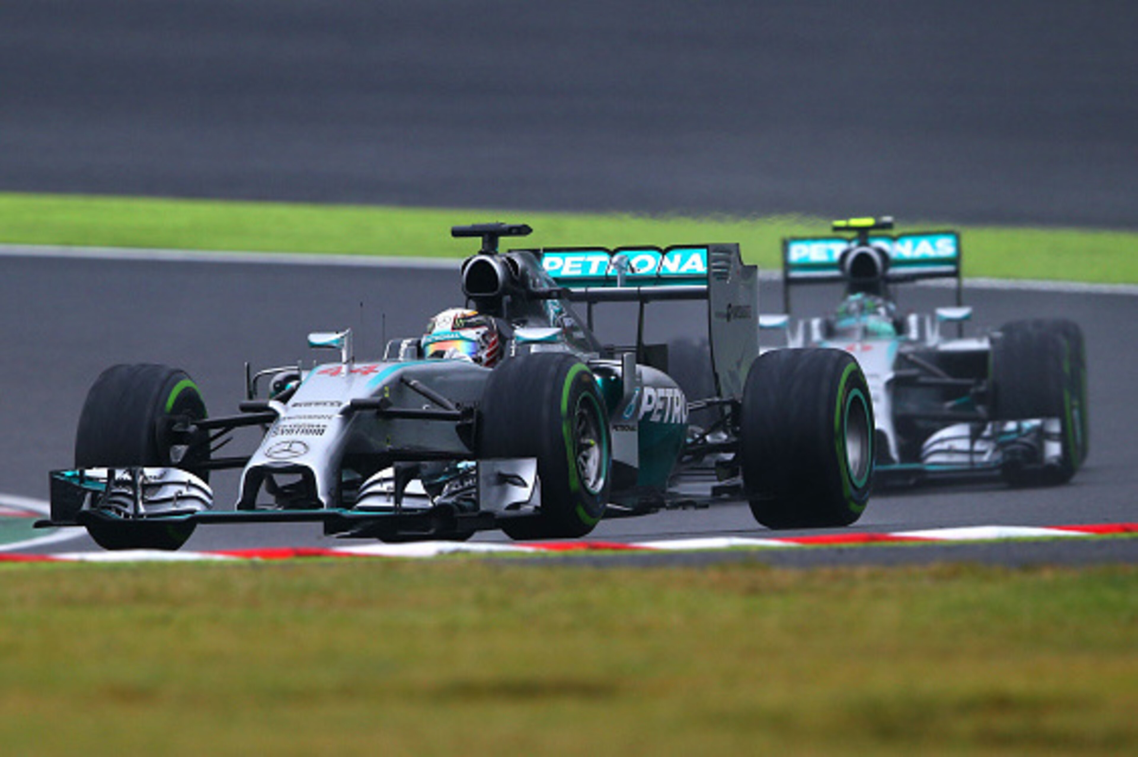 SUZUKA, JAPAN - OCTOBER 05: Lewis Hamilton of Great Britain and Mercedes GP leads teammate Nico Rosberg of Germany and Mercedes GP during the Japanese Formula One Grand Prix at Suzuka Circuit on October 5, 2014 in Suzuka, Japan. (Photo by Mark Thompson/Ge