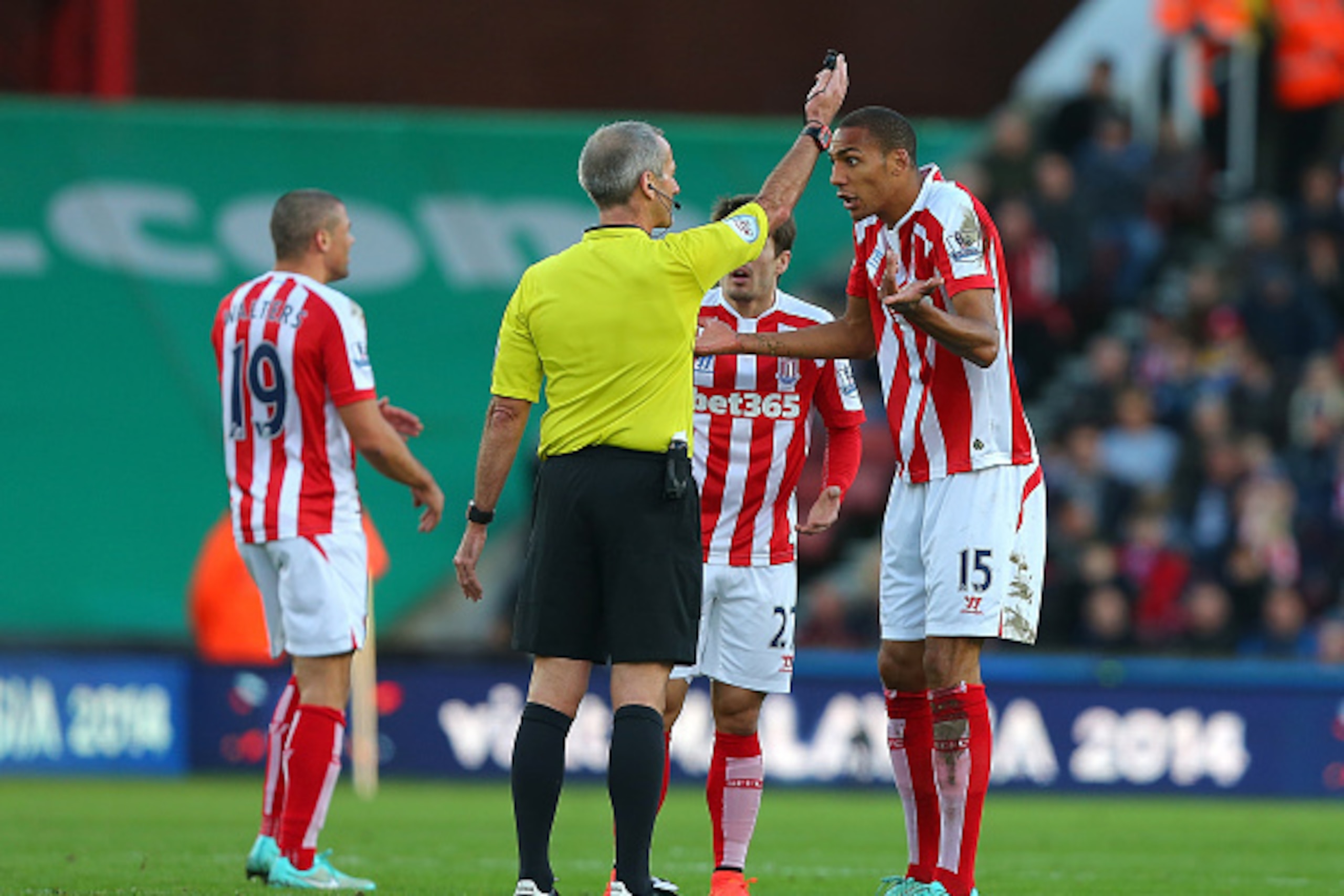 STOKE ON TRENT, ENGLAND - NOVEMBER 22:  Steven Nzonzi of Stoke City and Referee Martin Atkinson exchange views during the Barclays Premier League match between Stoke City and Burnley at the Britannia Stadium on November 22, 2014 in Stoke on Trent, England