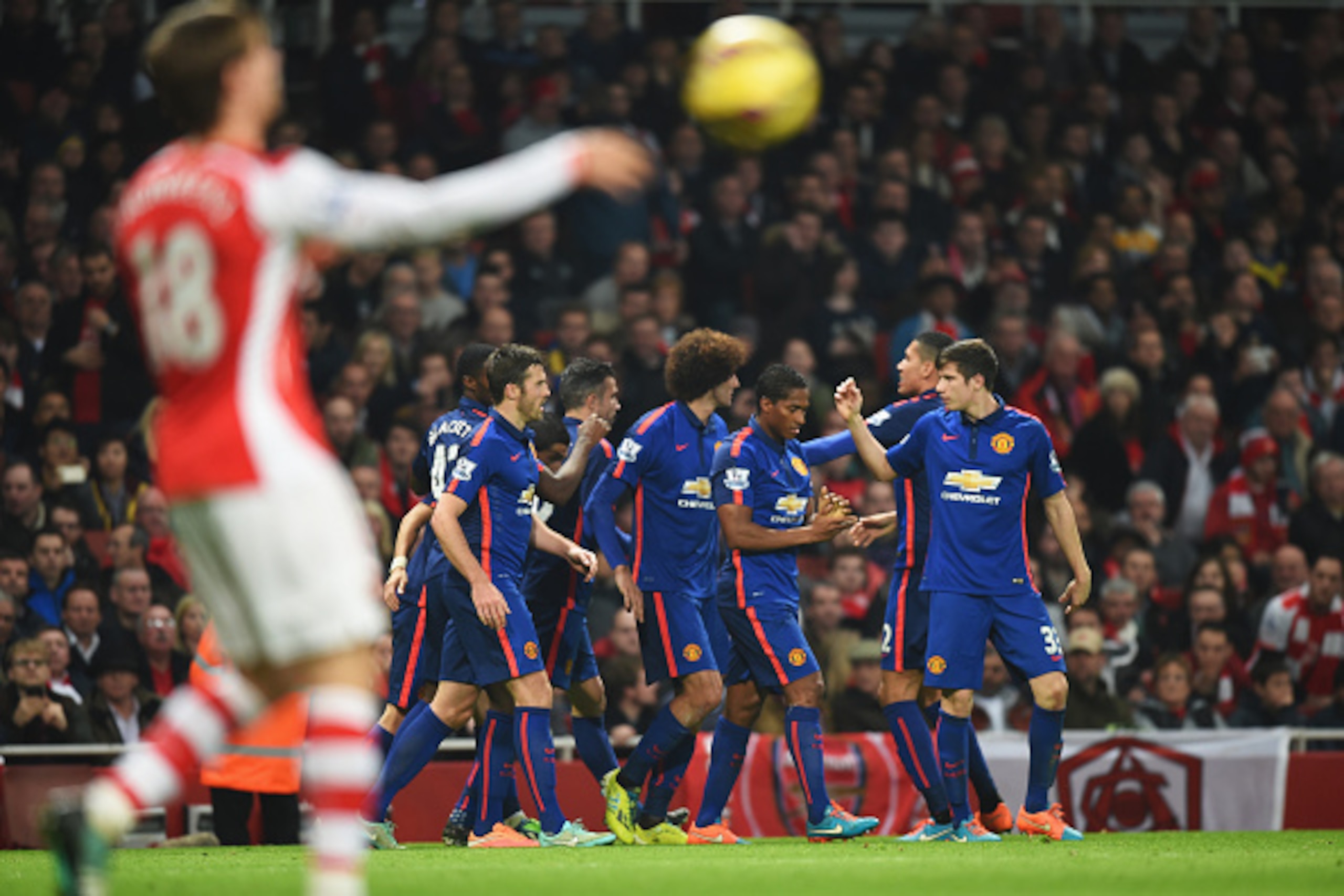 LONDON, ENGLAND - NOVEMBER 22: Manchester United players celebrate the own goal scored by Kieran Gibbs of Arsenal during the Barclays Premier League match between Arsenal and Manchester United at Emirates Stadium on November 22, 2014 in London, England.  