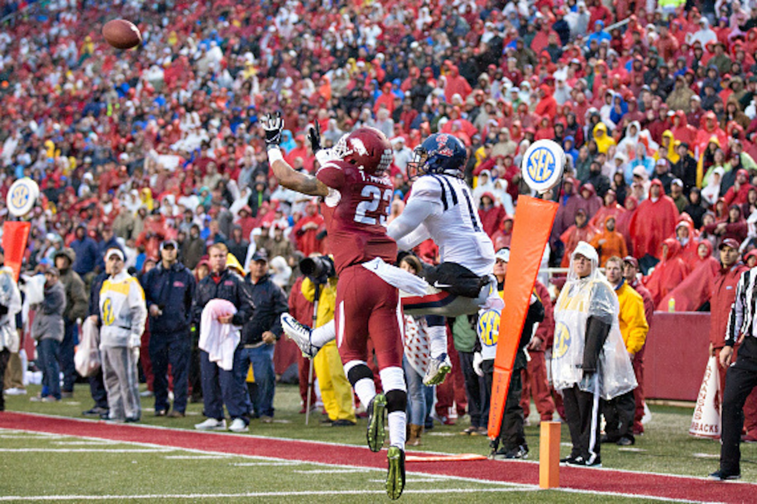 FAYETTEVILLE, AR - NOVEMBER 22:  Tevin Mitchel #23 of the Arkansas Razorbacks intercepts a pass in the end zone in the second quarter in front of Markell Pack #11 of the Ole Miss Rebels at Razorback Stadium on November 22, 2014 in Fayetteville, Arkansas. 