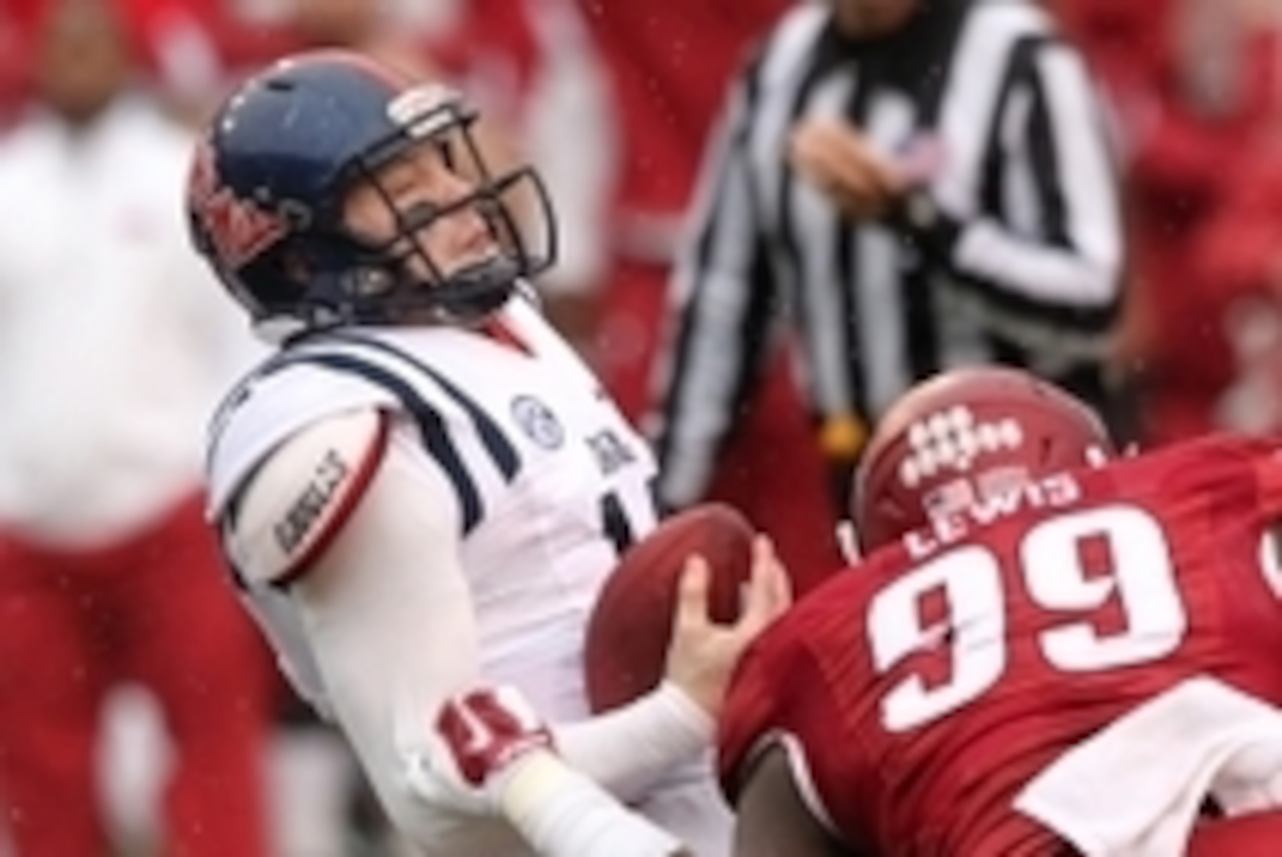 Nov 22, 2014; Fayetteville, AR, USA; Ole Miss Rebels quarterback Bo Wallace (14) fumbles and is injured on the play in the first half against the Arkansas Razorbacks at Donald W. Reynolds Razorback Stadium. Mandatory Credit: Nelson Chenault-USA TODAY Spor Nov 22, 2014; Fayetteville, AR, USA; Ole Miss Rebels quarterback Bo Wallace (14) fumbles and is injured on the play in the first half against the Arkansas Razorbacks at Donald W. Reynolds Razorback Stadium. Mandatory Credit: Nelson Chenault-USA TODAY Spor