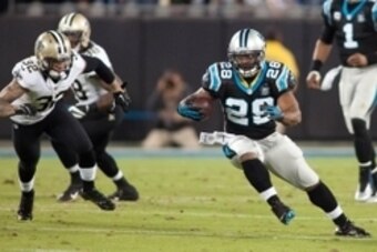 Oct 30, 2014; Charlotte, NC, USA; Carolina Panthers running back Jonathan Stewart (28) runs the ball while New Orleans Saints strong safety Kenny Vaccaro (32) pursues during the first quarter at Bank of America Stadium. Mandatory Credit: Jeremy Brevard-US