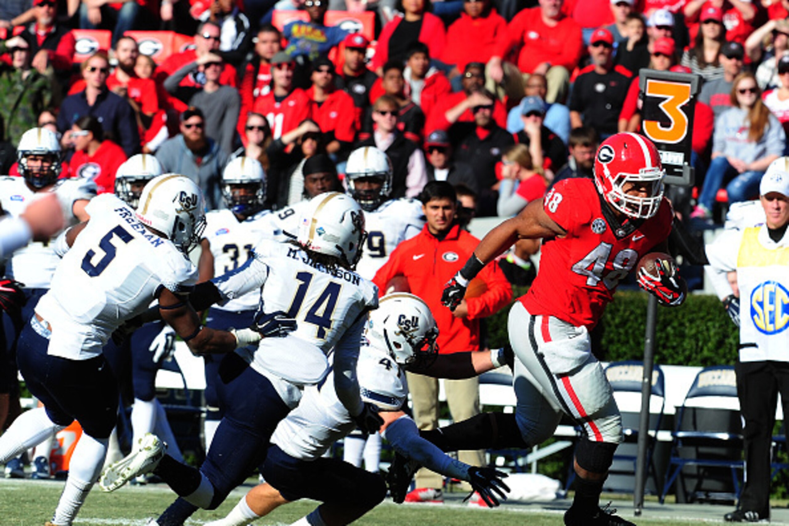 ATHENS, GA - NOVEMBER 22: Quayvon Hicks #48 of the Georgia Bulldogs breaks a tackle for a 33 yard touchdown run against the Charleston Southern Buccaneers at Sanford Stadium on November 22, 2014 in Athens, Georgia. (Photo by Scott Cunningham/Getty Images)