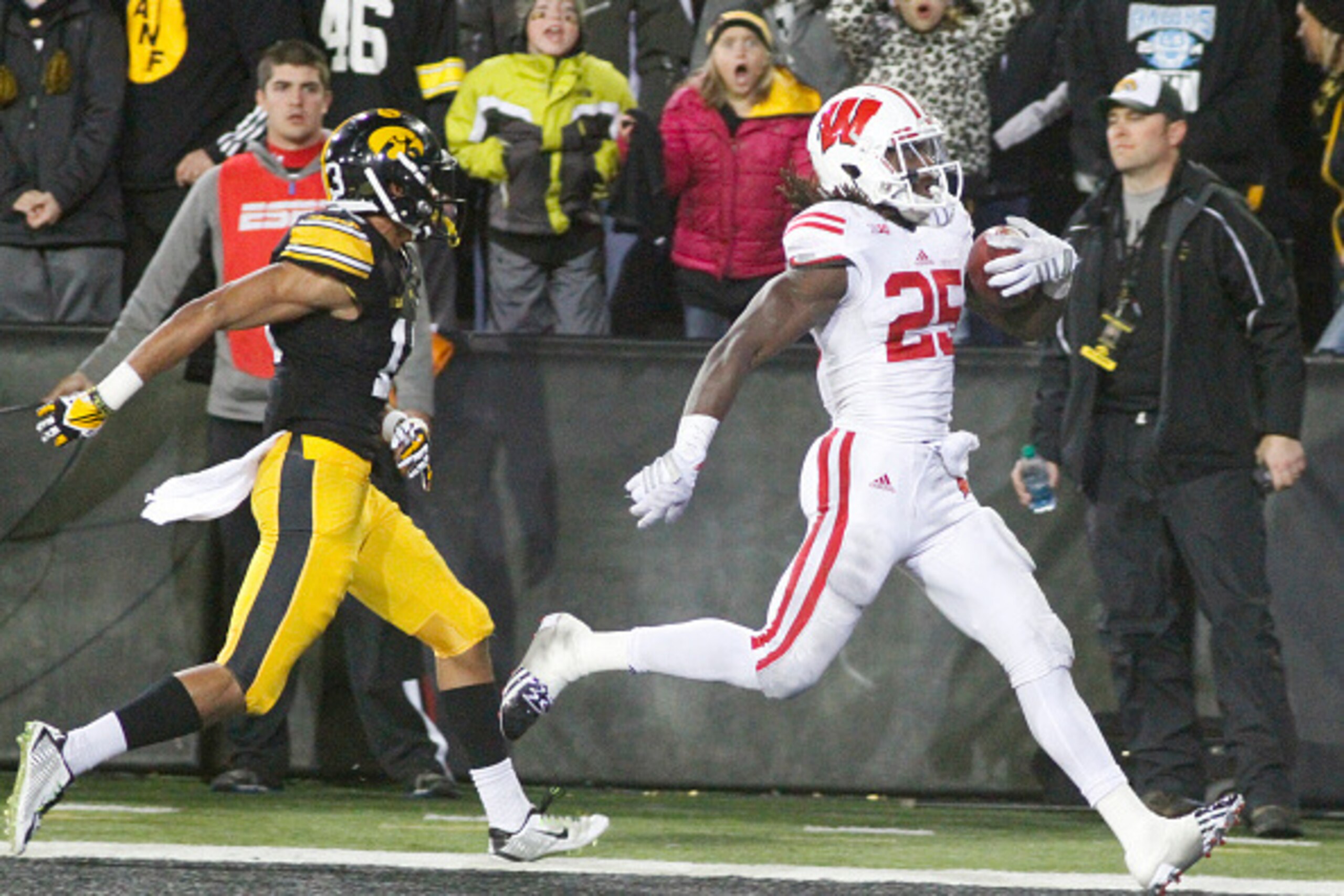 IOWA CITY, IA - NOVEMBER 22: Running back Melvin Gordon #25 of the Wisconsin Badgers runs in for a touchdown in front of defensive back Greg Mabin #13 of the Iowa Hawkeyes, in the fourth quarter on November 22, 2014 at Kinnick Stadium, in Iowa City, Iowa.