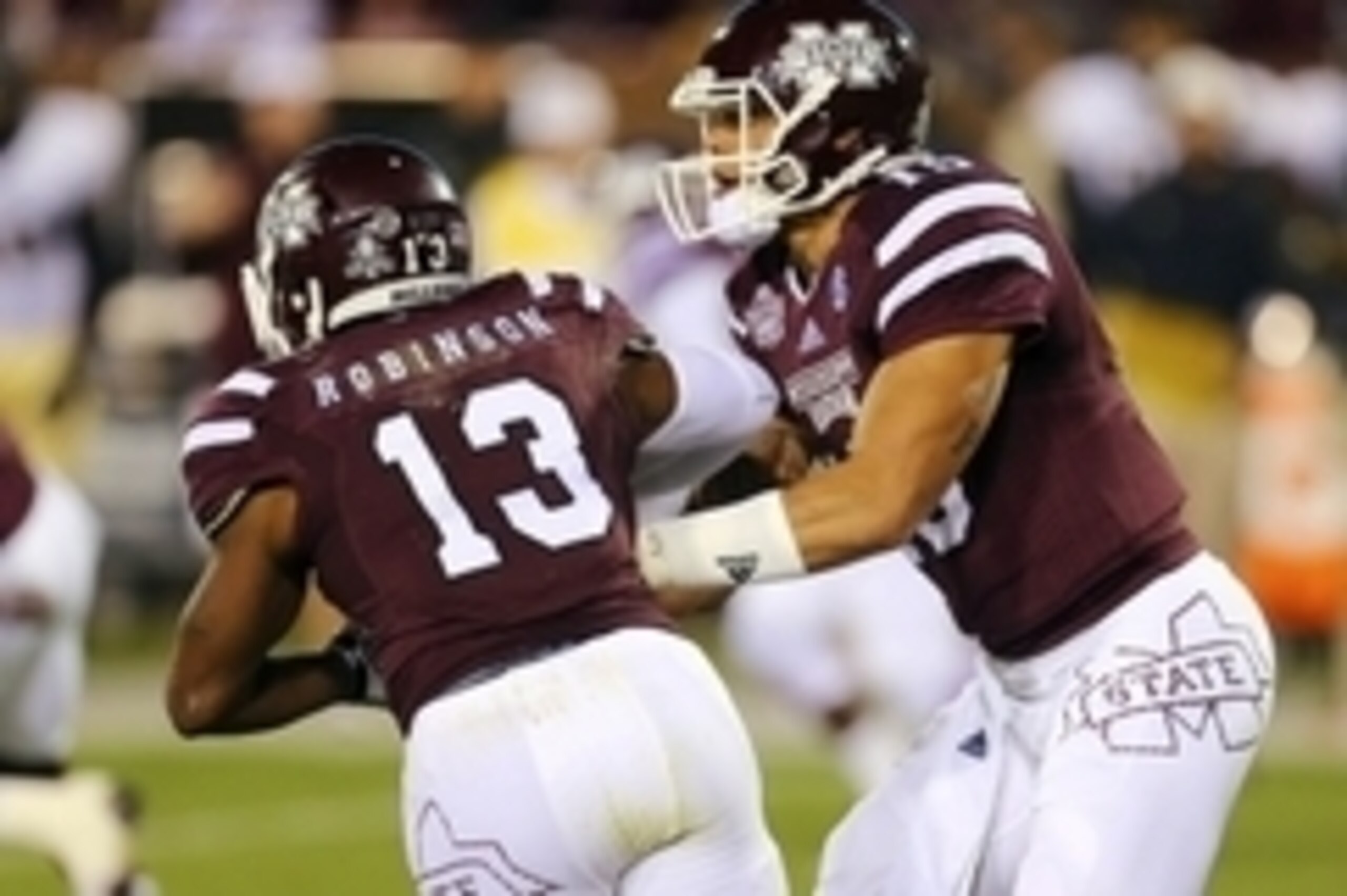 Nov 22, 2014; Starkville, MS, USA; Mississippi State Bulldogs quarterback Dak Prescott (15) hands the ball off to running back Josh Robinson (13) during the game against Vanderbilt at Davis Wade Stadium. Mandatory Credit: Spruce Derden-USA TODAY Sports