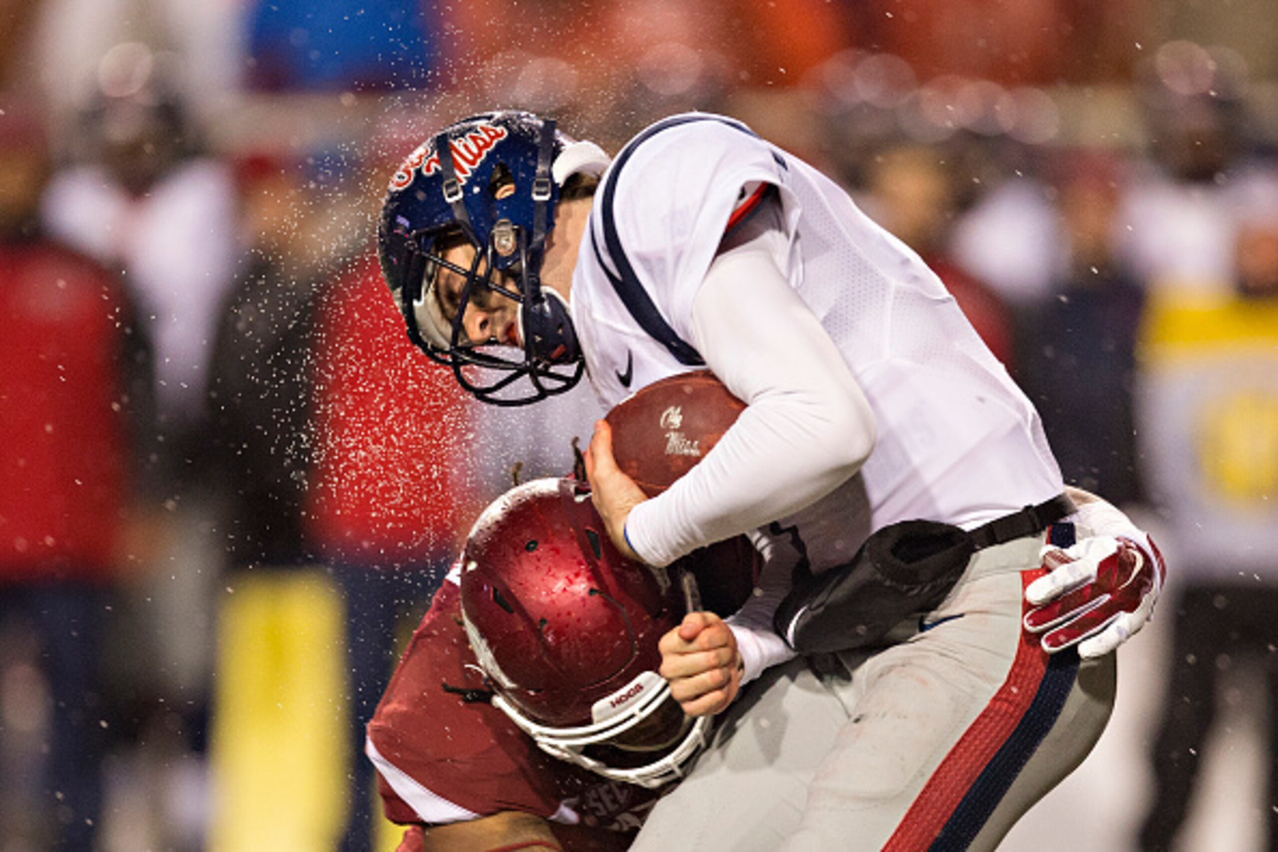FAYETTEVILLE, AR - NOVEMBER 22:  Ryan Buchanan #9 of the Ole Miss Rebels is tackled in the fourth quarter by Darius Philon #91 of the Arkansas Razorbacks at Razorback Stadium on November 22, 2014 in Fayetteville, Arkansas.  The Razorbacks defeated the Reb