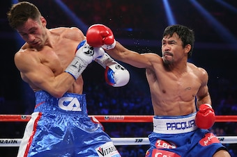 MACAU - NOVEMBER 23:  Manny Pacquiao of the Philippines and Chris Algieri of the United States exchange punches during the WBO world welterweight title at The Venetian on November 23, 2014 in Macau, Macau.