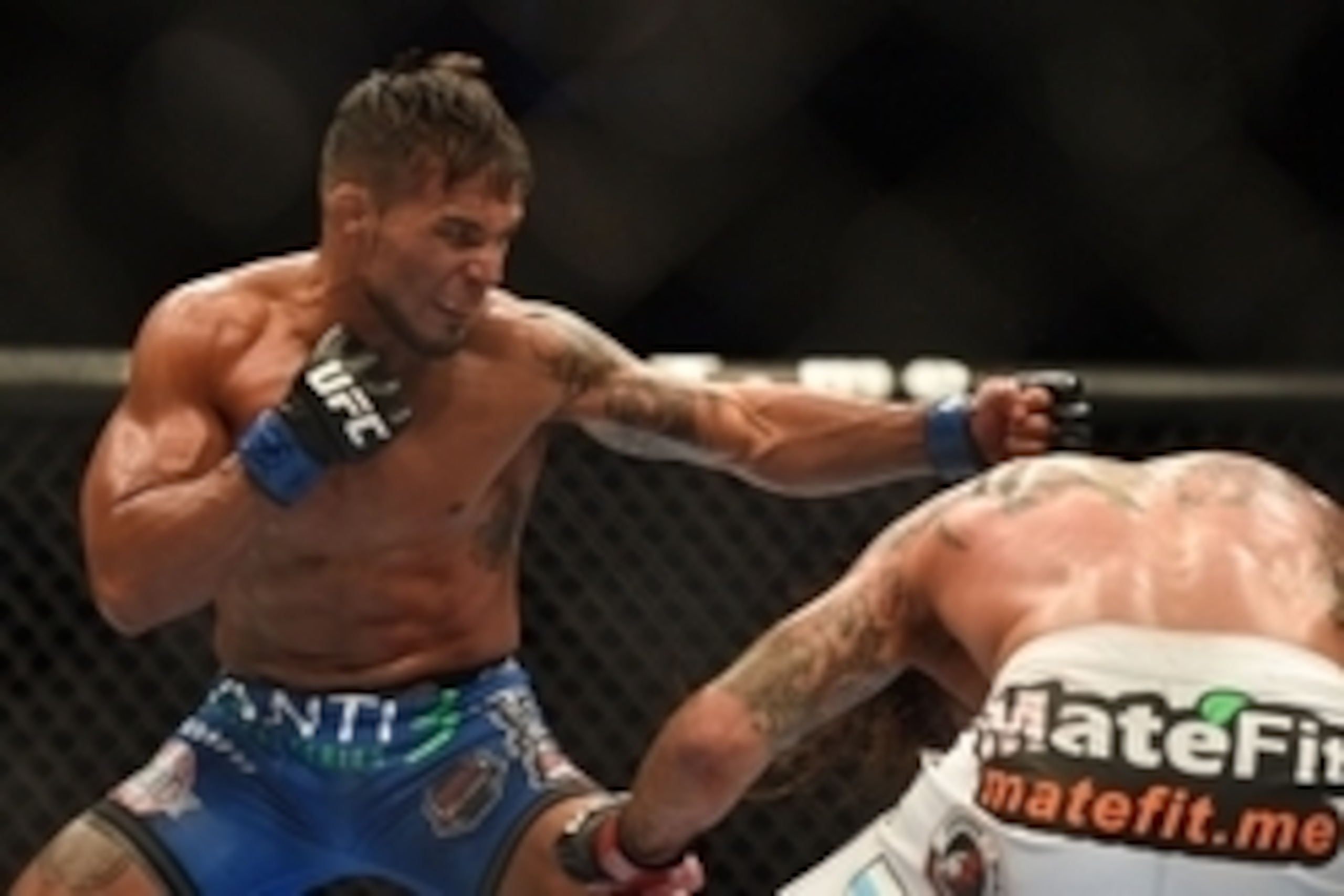 July 26, 2014; San Jose, CA, USA; Dennis Bermudez (blue gloves) fights Clay Guida (red gloves) during the featherweight bout of the FOX UFC Saturday at SAP Center. Mandatory Credit: Kyle Terada-USA TODAY Sports