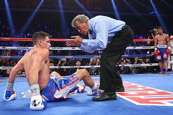 MACAU - NOVEMBER 23:  Manny Pacquiao of the Philippines knockes down Chris Algieri of the United States during the world welterweight title at The Venetian on November 23, 2014 in Macau, Macau.  (Photo by Chris Hyde/Getty Images)