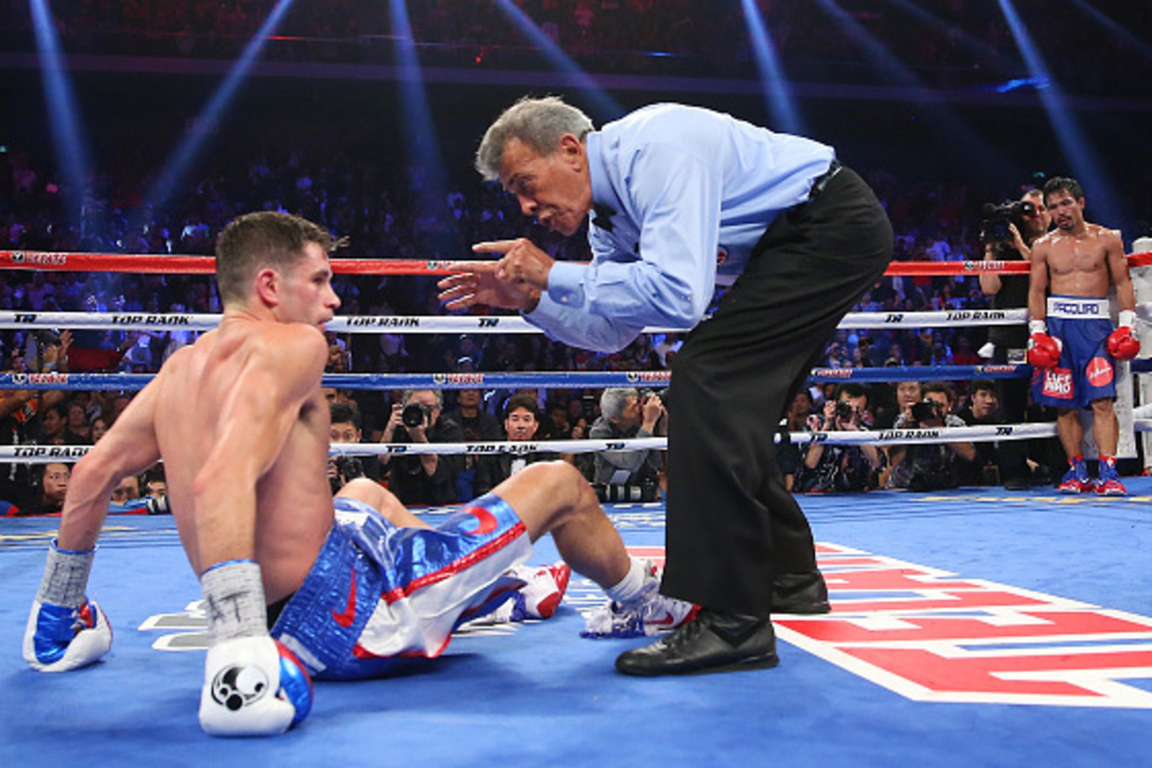MACAU - NOVEMBER 23:  Manny Pacquiao of the Philippines knockes down Chris Algieri of the United States during the world welterweight title at The Venetian on November 23, 2014 in Macau, Macau.  (Photo by Chris Hyde/Getty Images)
