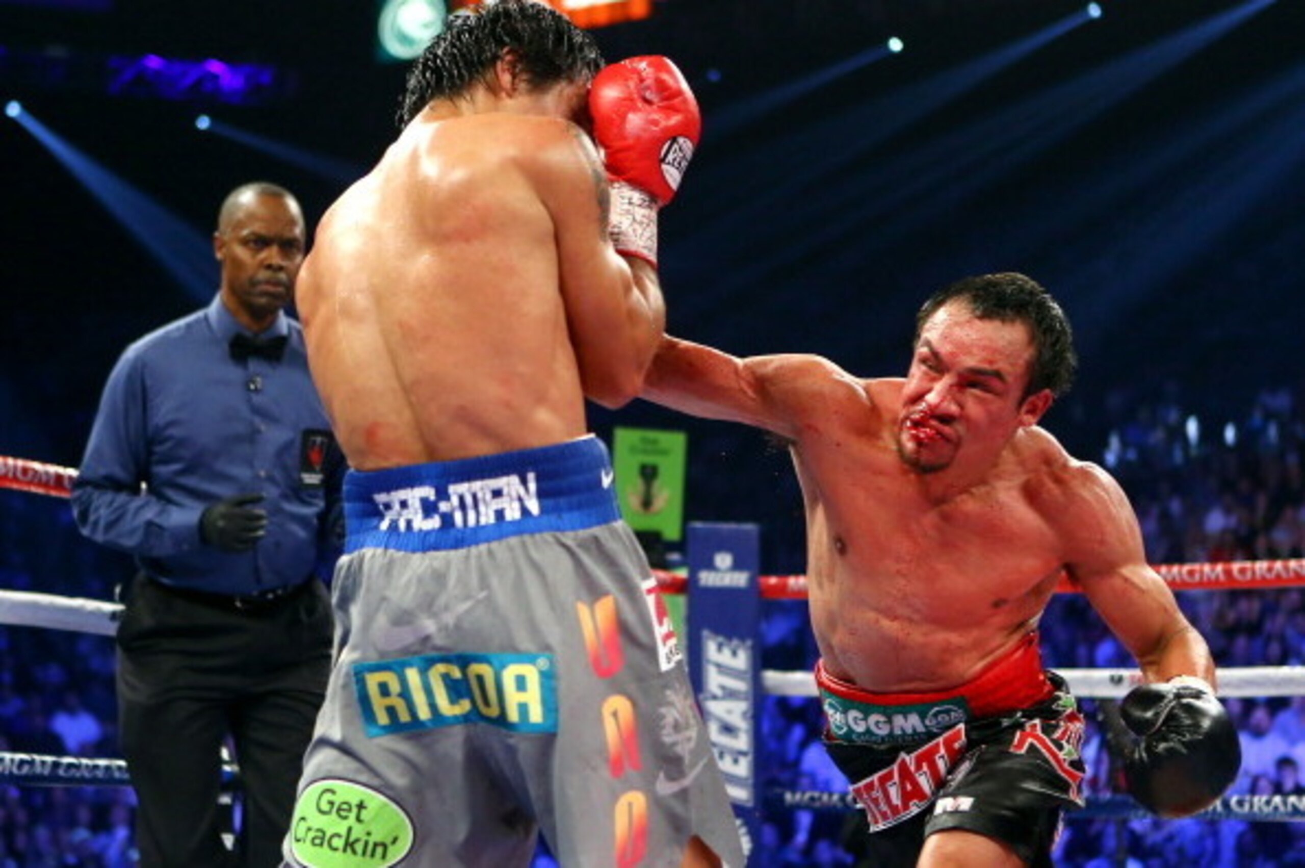 LAS VEGAS, NV - DECEMBER 08:  (R-L) Juan Manuel Marquez lands a right to the face of Manny Pacquiao during their welterweight bout at the MGM Grand Garden Arena on December 8, 2012 in Las Vegas, Nevada.  (Photo by Al Bello/Getty Images)