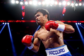 MACAU - NOVEMBER 23:  Manny Pacquiao of the Philippines punches Chris Algieri of the United States during the WBO world welterweight title at The Venetian on November 23, 2014 in Macau, Macau.  (Photo by Chris Hyde/Getty Images)