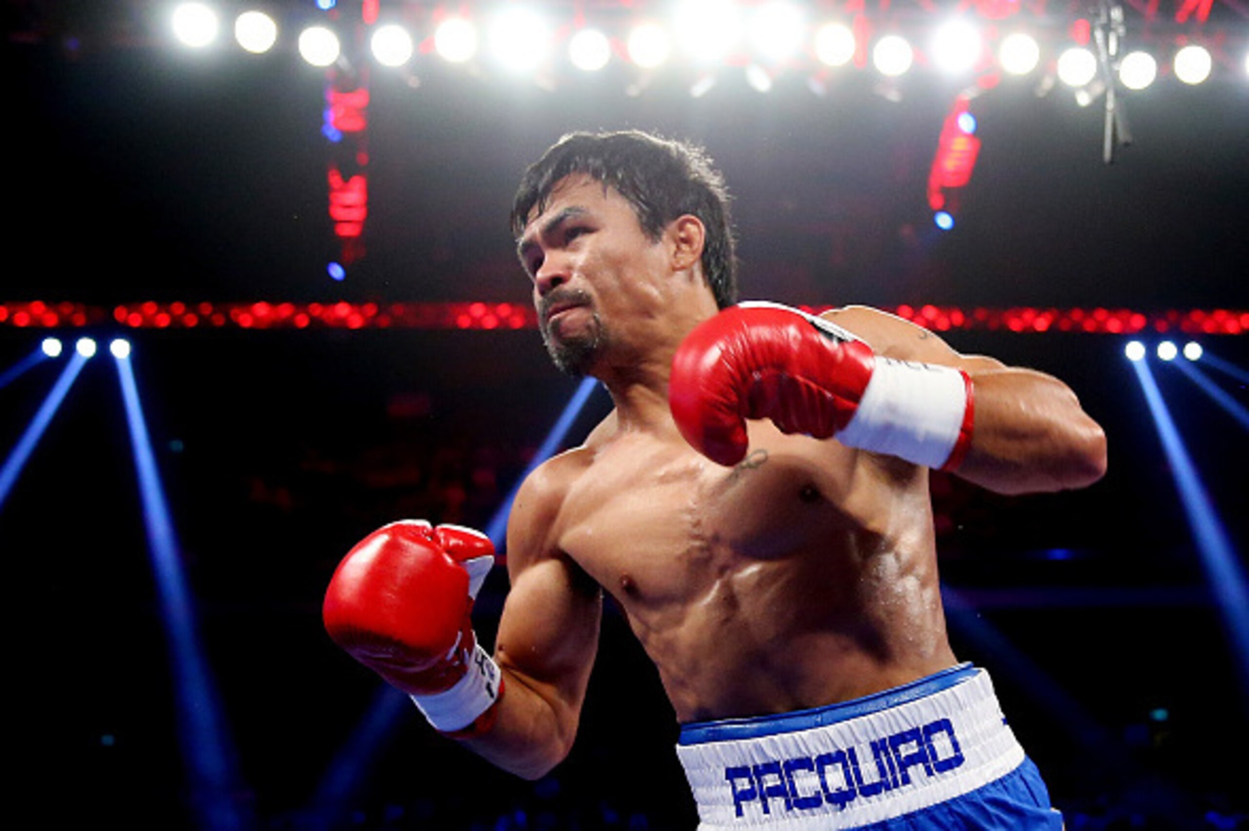 MACAU - NOVEMBER 23:  Manny Pacquiao of the Philippines punches Chris Algieri of the United States during the WBO world welterweight title at The Venetian on November 23, 2014 in Macau, Macau.  (Photo by Chris Hyde/Getty Images)