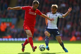 LIVERPOOL, ENGLAND - OCTOBER 04:  Rickie Lambert of Liverpool and Craig Dawson of West Brom battle for the ball during the Barclays Premier League match between Liverpool and West Bromwich Albion at Anfield on October 4, 2014 in Liverpool, England.  (Phot