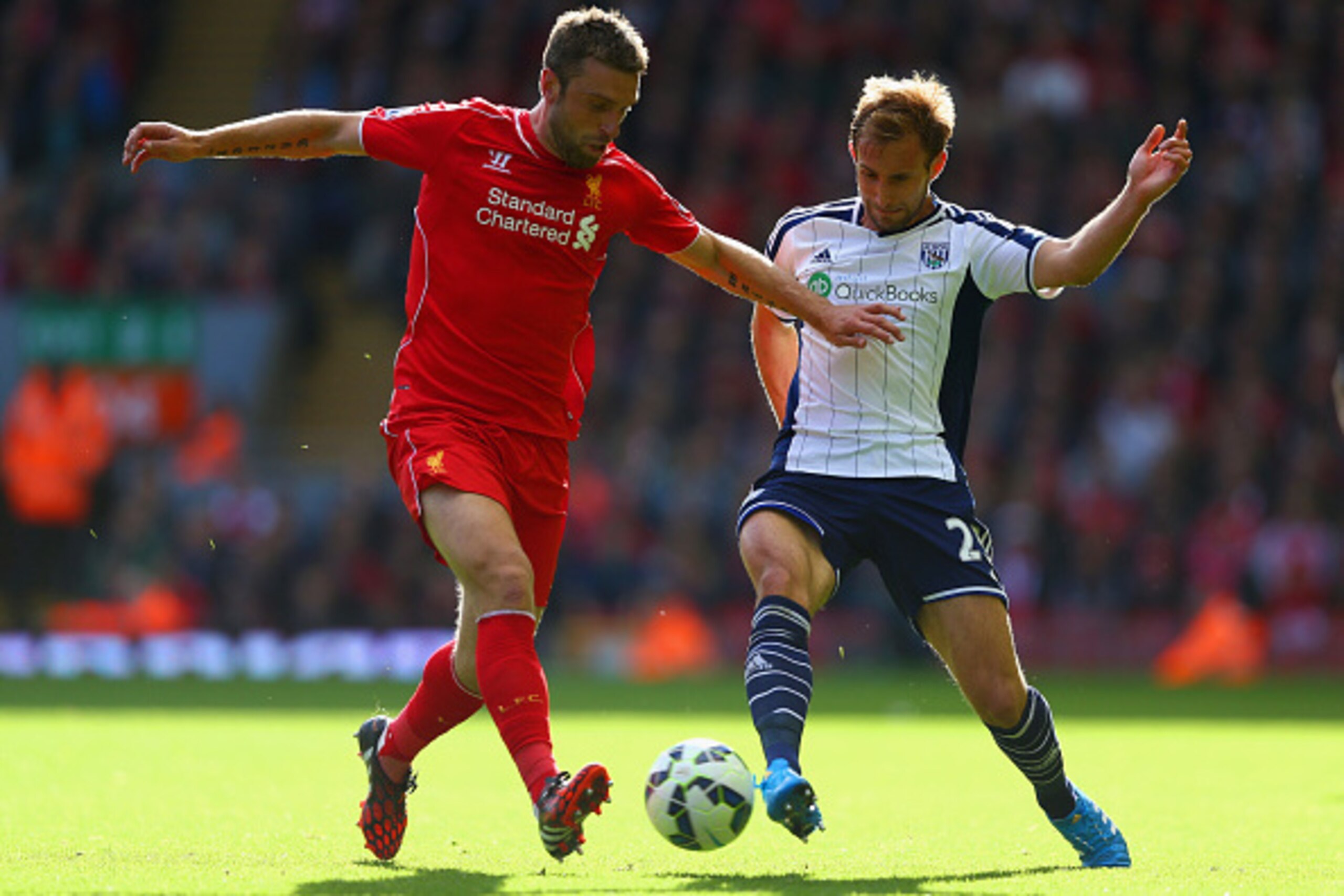 LIVERPOOL, ENGLAND - OCTOBER 04:  Rickie Lambert of Liverpool and Craig Dawson of West Brom battle for the ball during the Barclays Premier League match between Liverpool and West Bromwich Albion at Anfield on October 4, 2014 in Liverpool, England.  (Phot