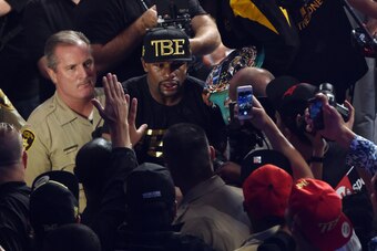 LAS VEGAS, NV - SEPTEMBER 13:  Floyd Mayweather Jr. greets fans as he leaves the ring after defeating Marcos Maidana by unanimous decision in their WBC/WBA welterweight title fight at the MGM Grand Garden Arena on September 13, 2014 in Las Vegas, Nevada. 