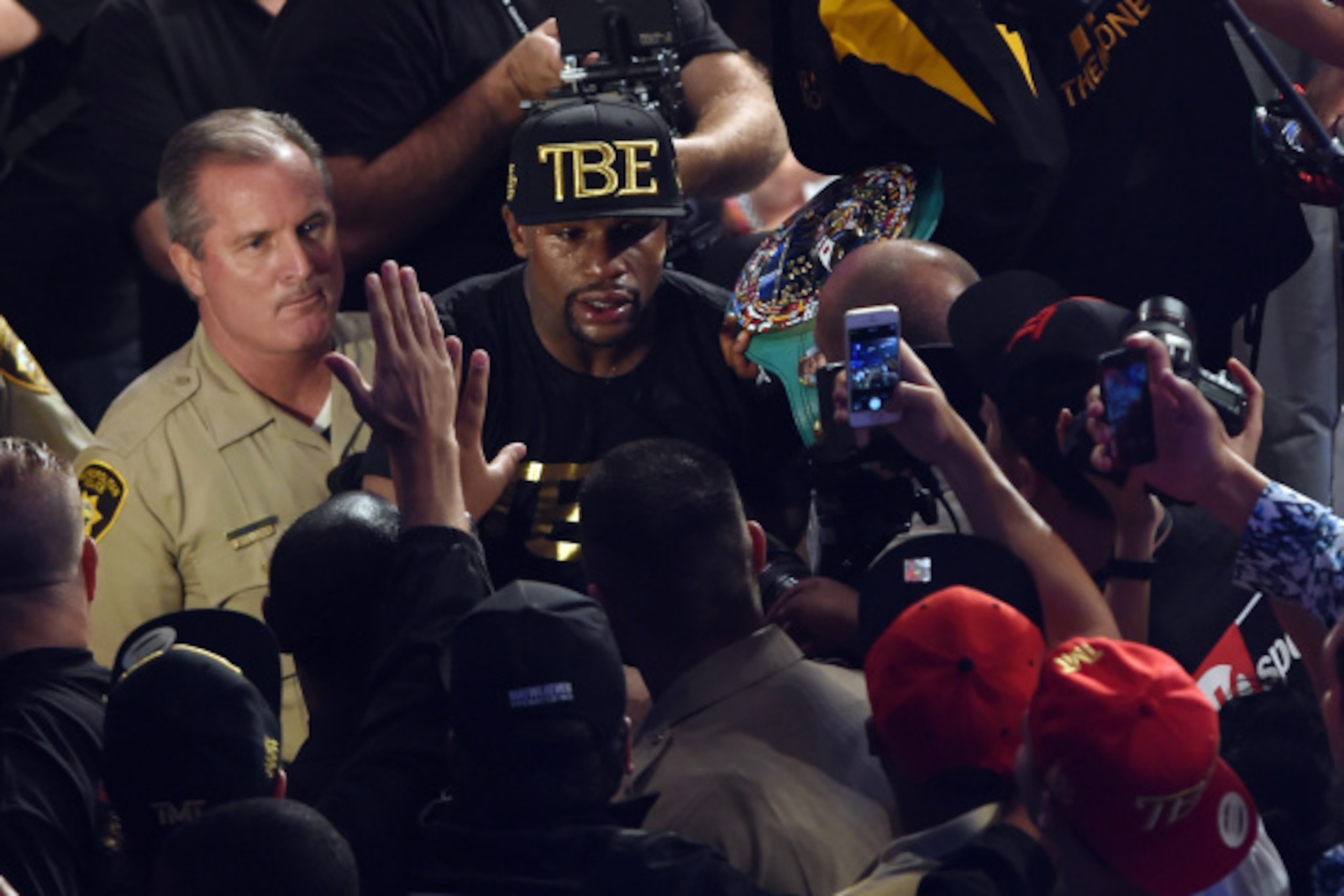 LAS VEGAS, NV - SEPTEMBER 13:  Floyd Mayweather Jr. greets fans as he leaves the ring after defeating Marcos Maidana by unanimous decision in their WBC/WBA welterweight title fight at the MGM Grand Garden Arena on September 13, 2014 in Las Vegas, Nevada. 