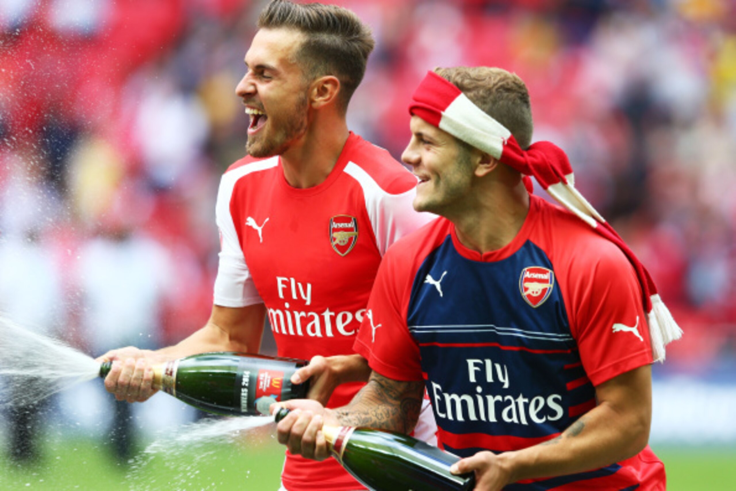 LONDON, ENGLAND - AUGUST 10: Aaron Ramsey and Jack Wilshere of Arsenal celebrate their win during the FA Community Shield match between Manchester City and Arsenal at Wembley Stadium on August 10, 2014 in London, England.  (Photo by Clive Mason/Getty Imag