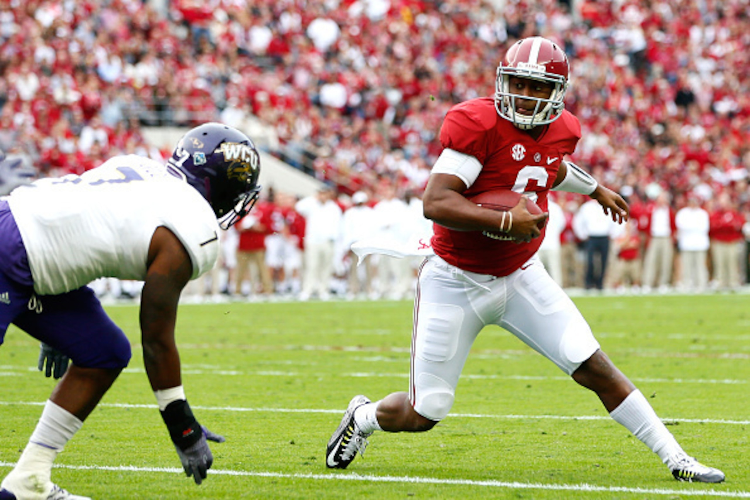 TUSCALOOSA, AL - NOVEMBER 22:  Blake Sims #6 of the Alabama Crimson Tide rushes against Christon Gill #7 of the Western Carolina Catamounts at Bryant-Denny Stadium on November 22, 2014 in Tuscaloosa, Alabama.  (Photo by Kevin C. Cox/Getty Images)