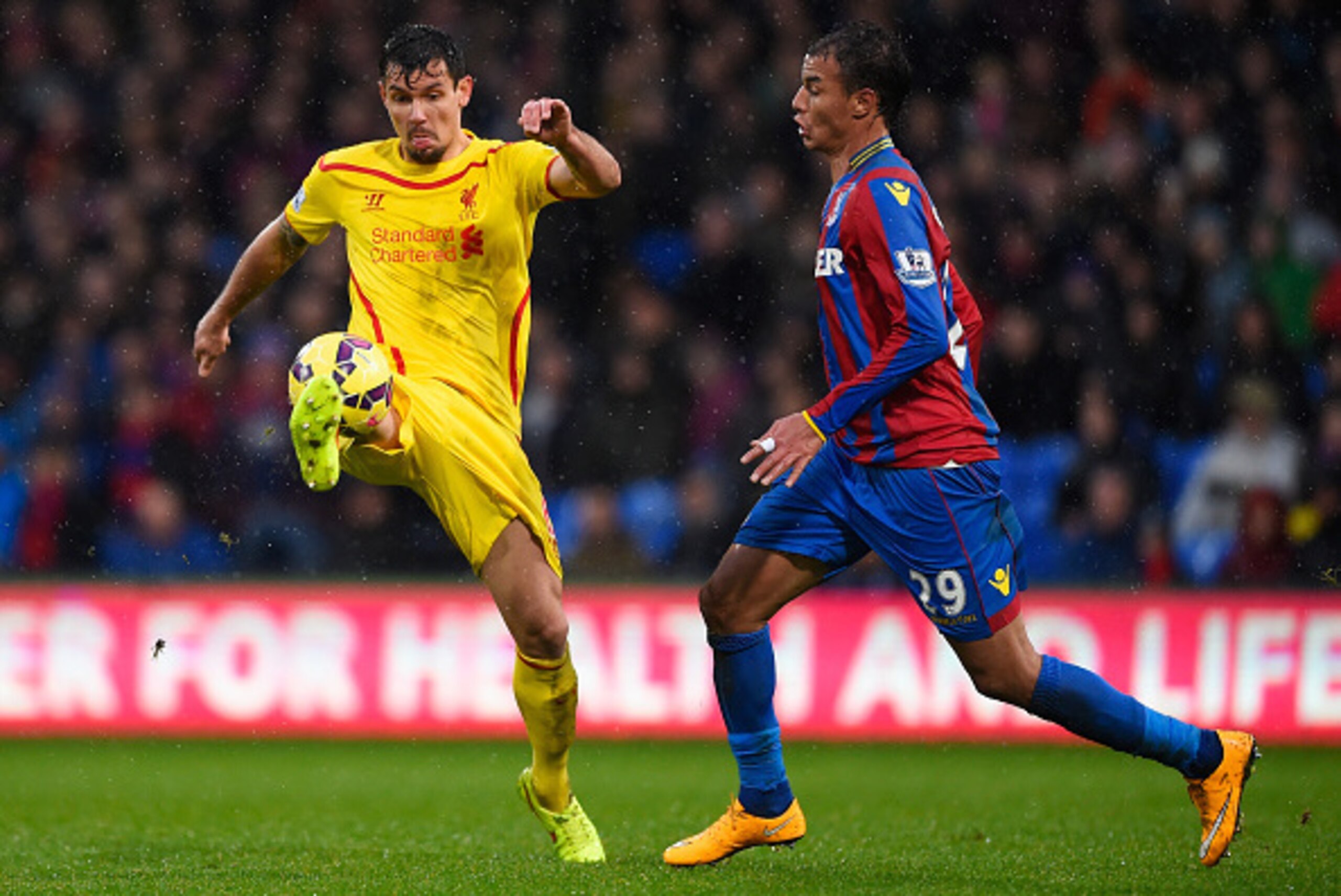 LONDON, ENGLAND - NOVEMBER 23: Dejan Lovren of Liverpool is closed down by Marouane Chamakh of Crystal Palace during the Barclays Premier League match between Crystal Palace and Liverpool at Selhurst Park on November 23, 2014 in London, England.  (Photo b