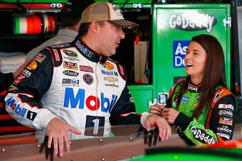 AVONDALE, AZ - NOVEMBER 08:  Tony Stewart, driver of the #14 Mobil 1/Bass Pro Shops Chevrolet, talks to Danica Patrick, driver of the #10 GoDaddy Chevrolet, in the garage area during practice for the NASCAR Sprint Cup Series Quicken Loans 500 at Phoenix I