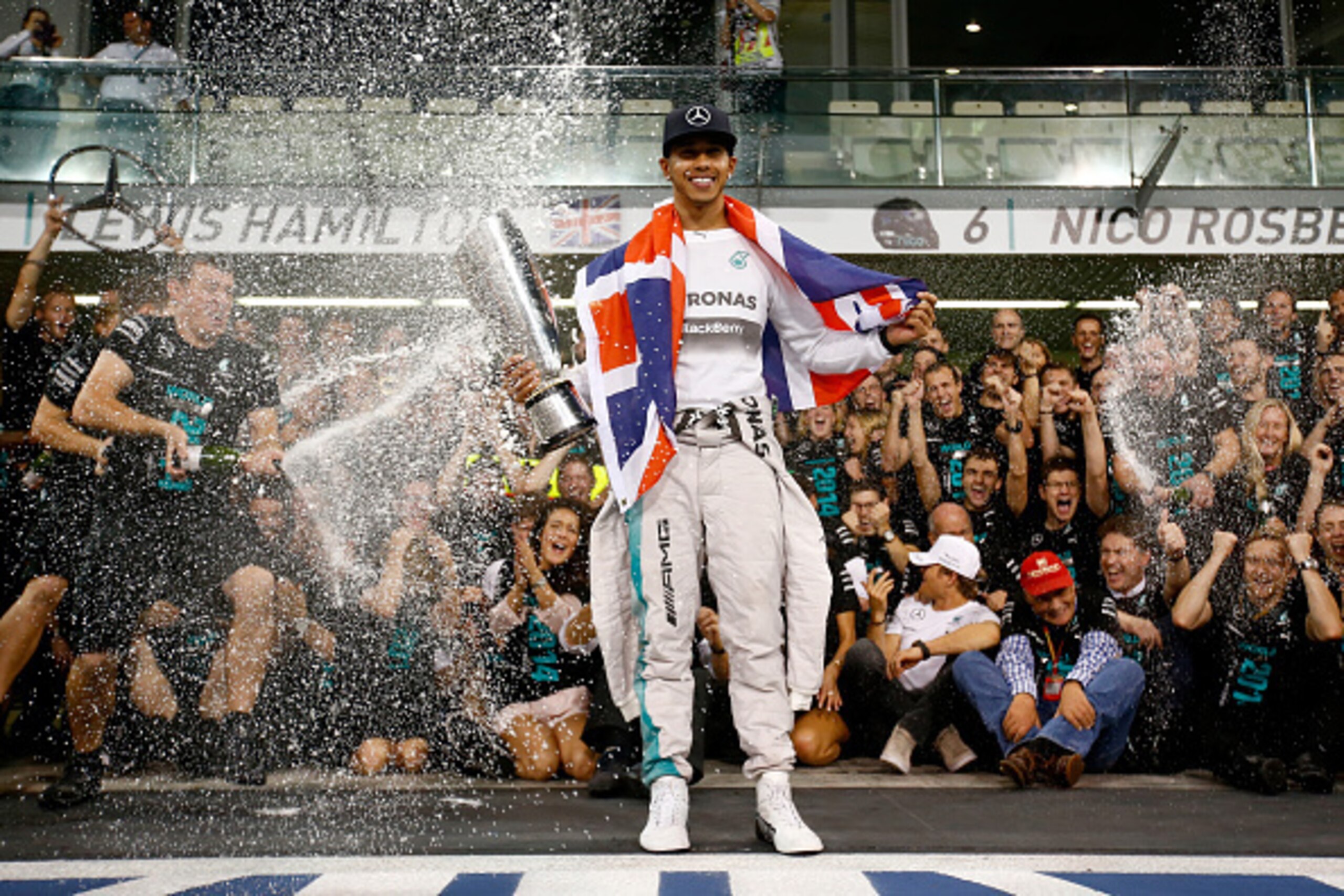 ABU DHABI, UNITED ARAB EMIRATES - NOVEMBER 23:  Lewis Hamilton of Great Britain and Mercedes GP celebrates with his team after winning the World Championship after the Abu Dhabi Formula One Grand Prix at Yas Marina Circuit on November 23, 2014 in Abu Dhab