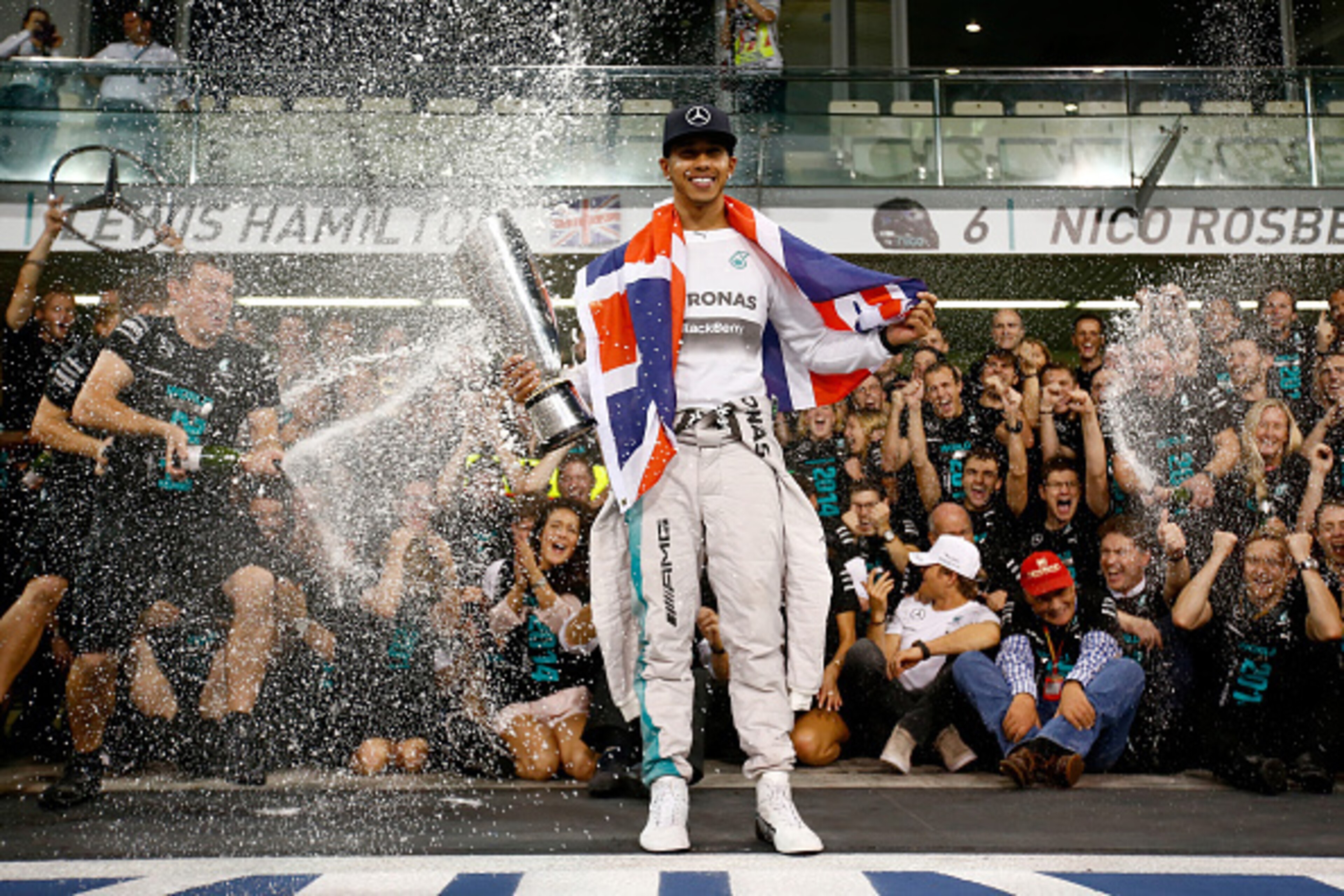 ABU DHABI, UNITED ARAB EMIRATES - NOVEMBER 23:  Lewis Hamilton of Great Britain and Mercedes GP celebrates with his team after winning the World Championship after the Abu Dhabi Formula One Grand Prix at Yas Marina Circuit on November 23, 2014 in Abu Dhab