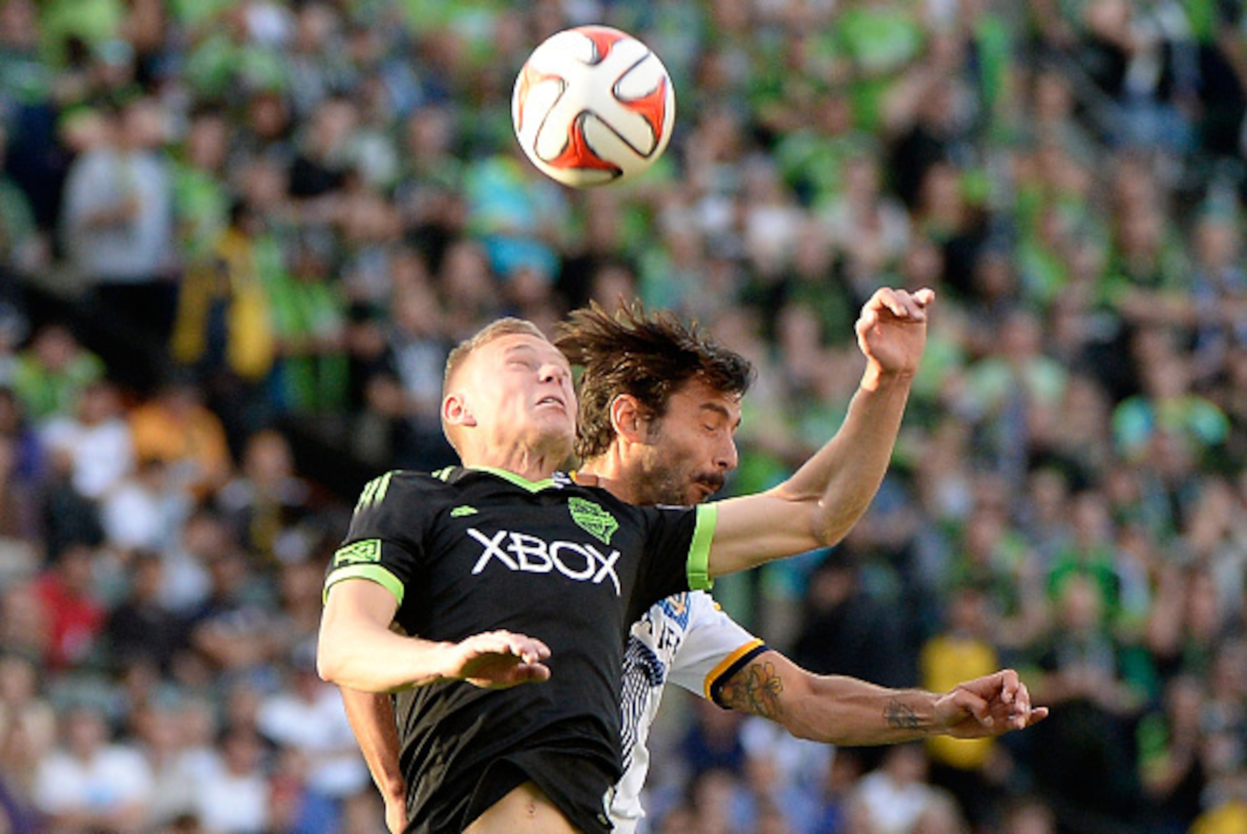 LOS ANGELES, CA - NOVEMBER 23:  Andy Rose #5 of Seattle Sounders FC and Baggio Husidic #6 of Los Angeles Galaxy head the ball during a 2-1 Galaxy win in the Western Conference Final at StubHub Center on November 23, 2014 in Los Angeles, California.  (Phot