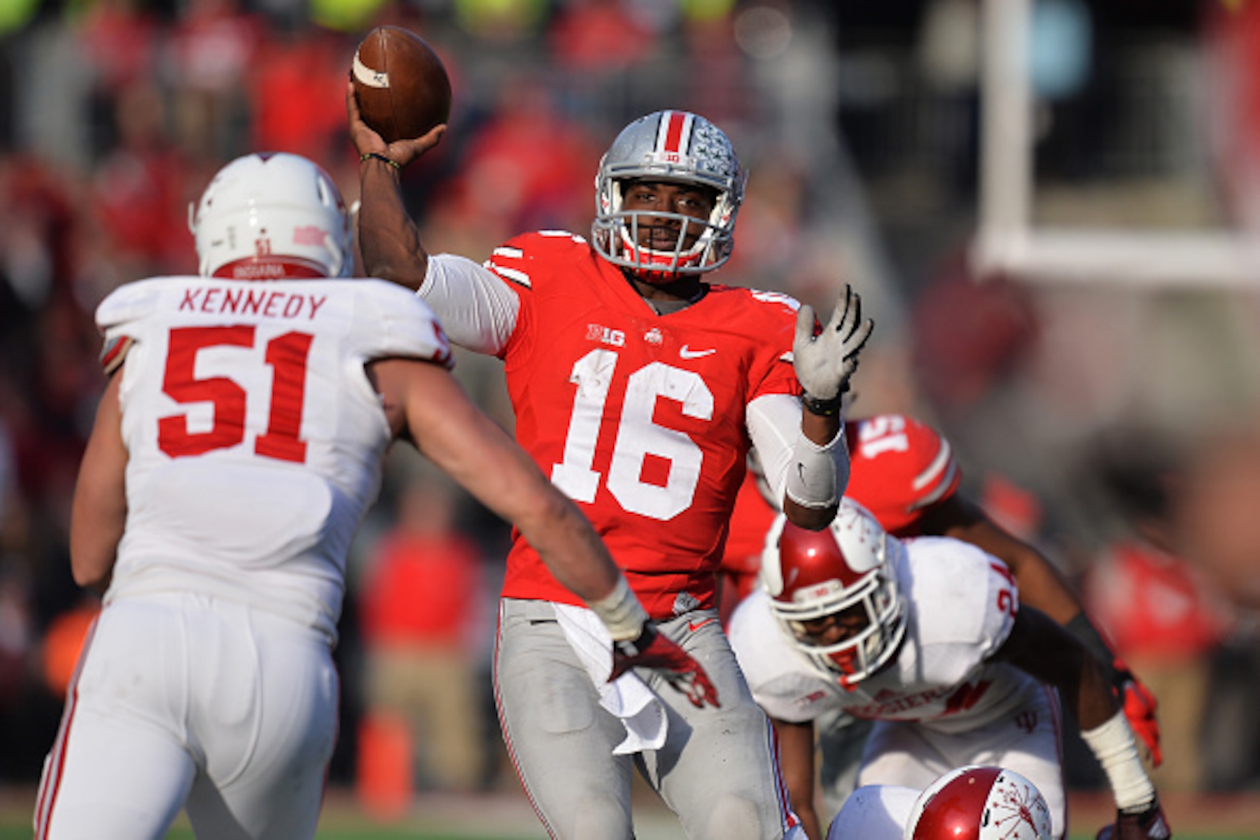 COLUMBUS, OH - NOVEMBER 22:  Quarterback J.T. Barrett #16 of the Ohio State Buckeyes throws against the Indiana Hoosiers defense in the fourth quarter at Ohio Stadium on November 22, 2014 in Columbus, Ohio. Barrett threw for four touchdown passes to lead 