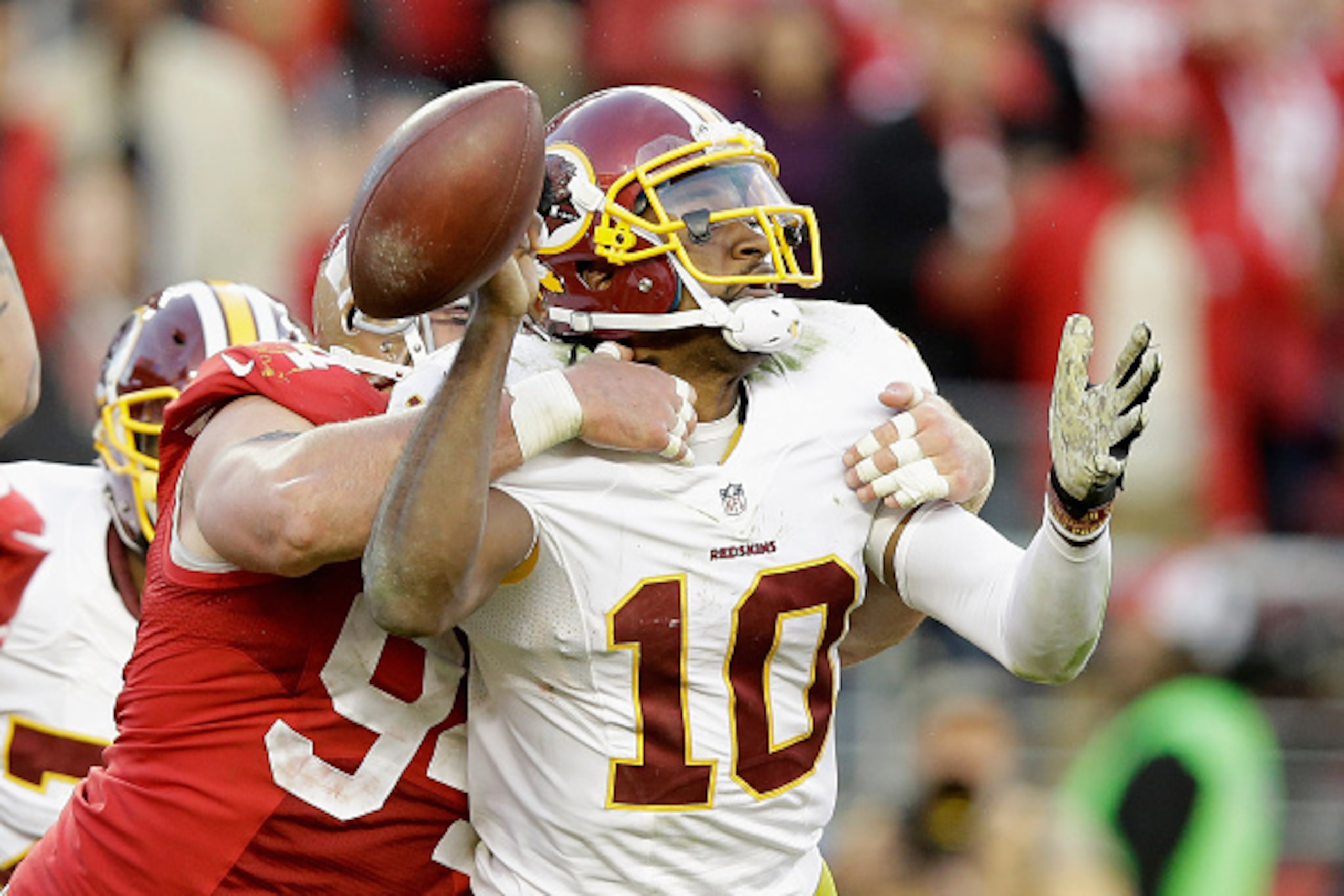 SANTA CLARA, CA - NOVEMBER 23:  Justin Smith #94 of the San Francisco 49ers forces a fumble from Robert Griffin III #10 of the Washington Redskins in the fourth quarter at Levi's Stadium on November 23, 2014 in Santa Clara, California.  (Photo by Ezra Sha