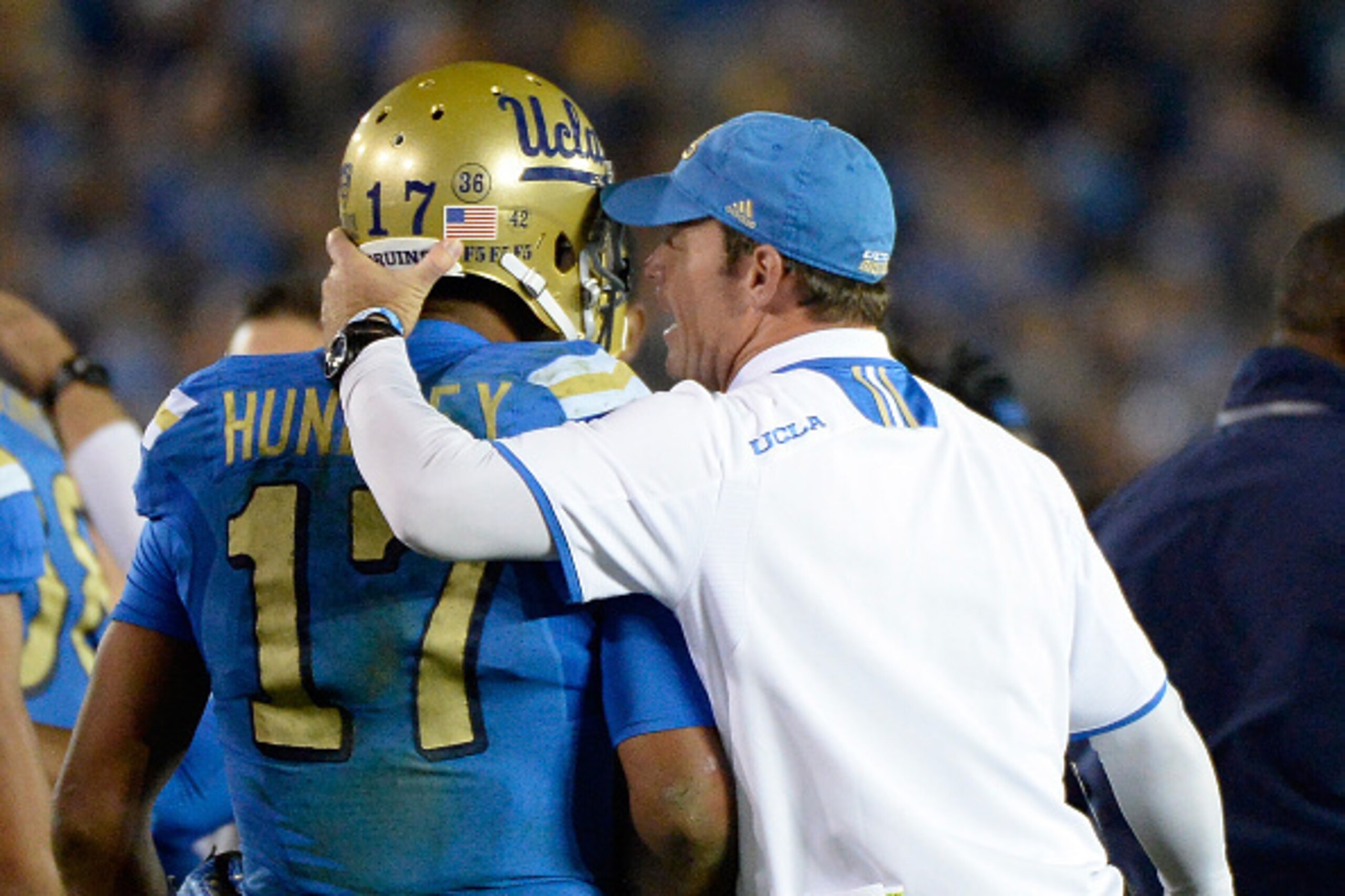PASADENA, CA - NOVEMBER 22:  Head coach Jim Mora of the UCLA Bruins speaks to Brett Hundley #17 after his touchodwn to take a 38-14 lead over the USC Trojans during the third quarter at the Rose Bowl on November 22, 2014 in Pasadena, California.  (Photo b