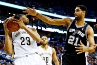 Feb 3, 2014; New Orleans, LA, USA; New Orleans Pelicans power forward Anthony Davis (23) and San Antonio Spurs power forward Tim Duncan (21) battle for a rebound during the first quarter of a game at the New Orleans Arena. Mandatory Credit: Derick E. Hing
