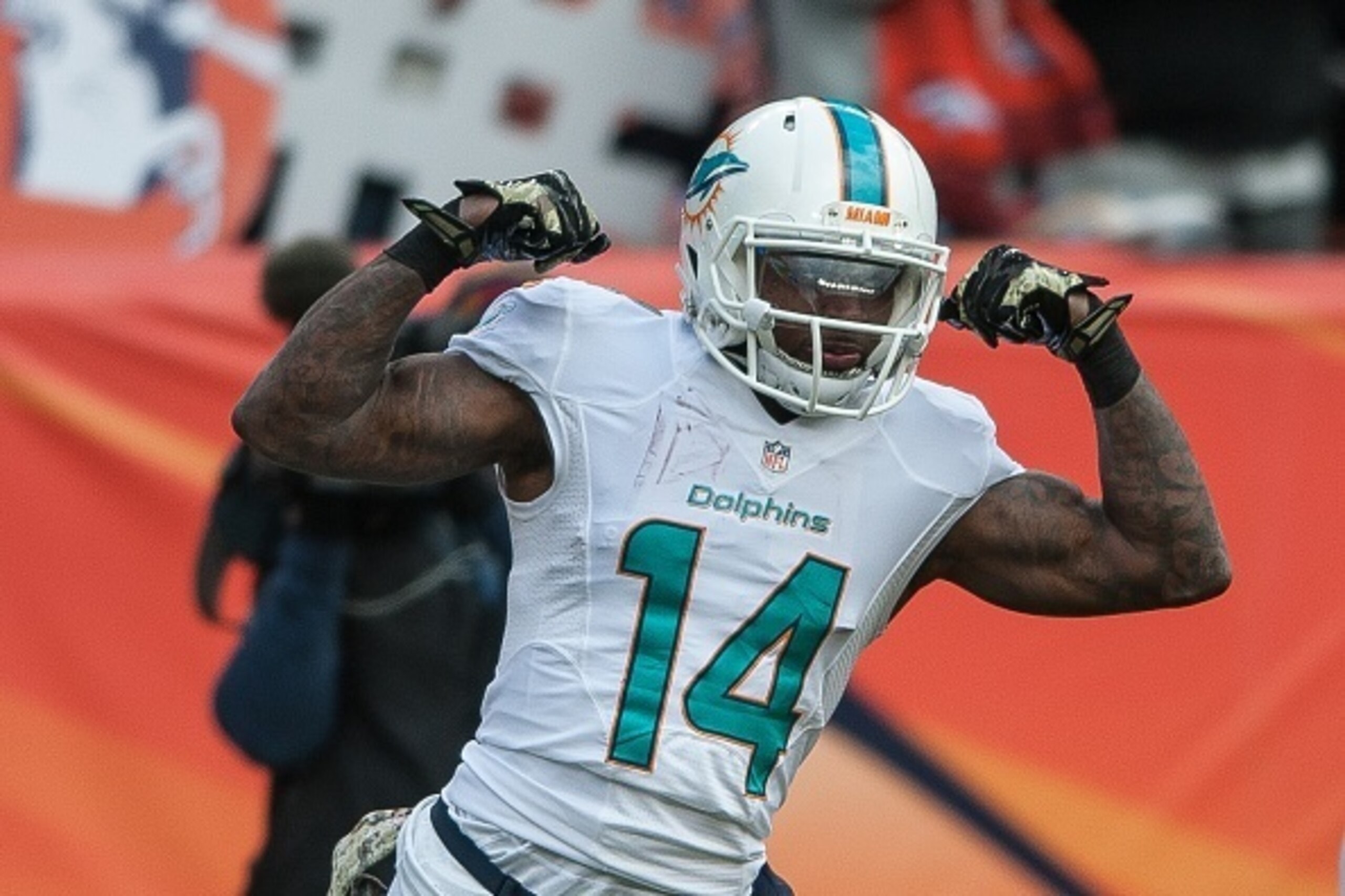 DENVER, CO - NOVEMBER 23:  Wide receiver Jarvis Landry #14 of the Miami Dolphins celebrates a 20-yard reception in the first quarter of a game against the Denver Broncos at Sports Authority Field at Mile High on November 23, 2014 in Denver, Colorado.  (Ph