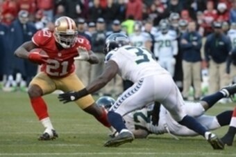 December 8, 2013; San Francisco, CA, USA; San Francisco 49ers running back Frank Gore (21) runs the football against Seattle Seahawks strong safety Kam Chancellor (31) during the fourth quarter at Candlestick Park. The 49ers defeated the Seahawks 19-17. M