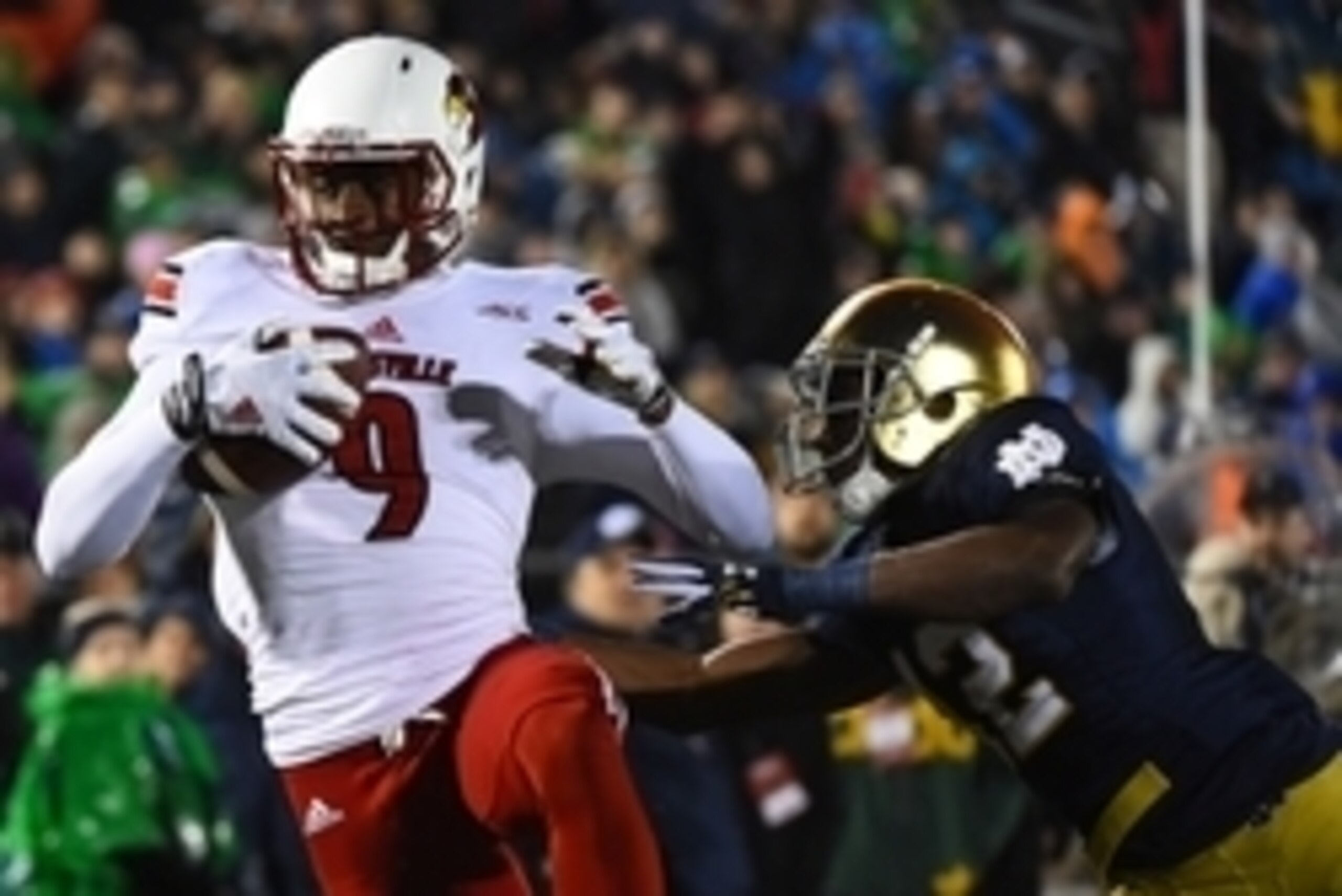 Nov 22, 2014; South Bend, IN, USA; Louisville Cardinals wide receiver DeVante Parker (9) makes a touchdown catch against Notre Dame Fighting Irish linebacker Michael Deeb (42) during the third quarter at Notre Dame Stadium. Mandatory Credit: Mike DiNovo-U