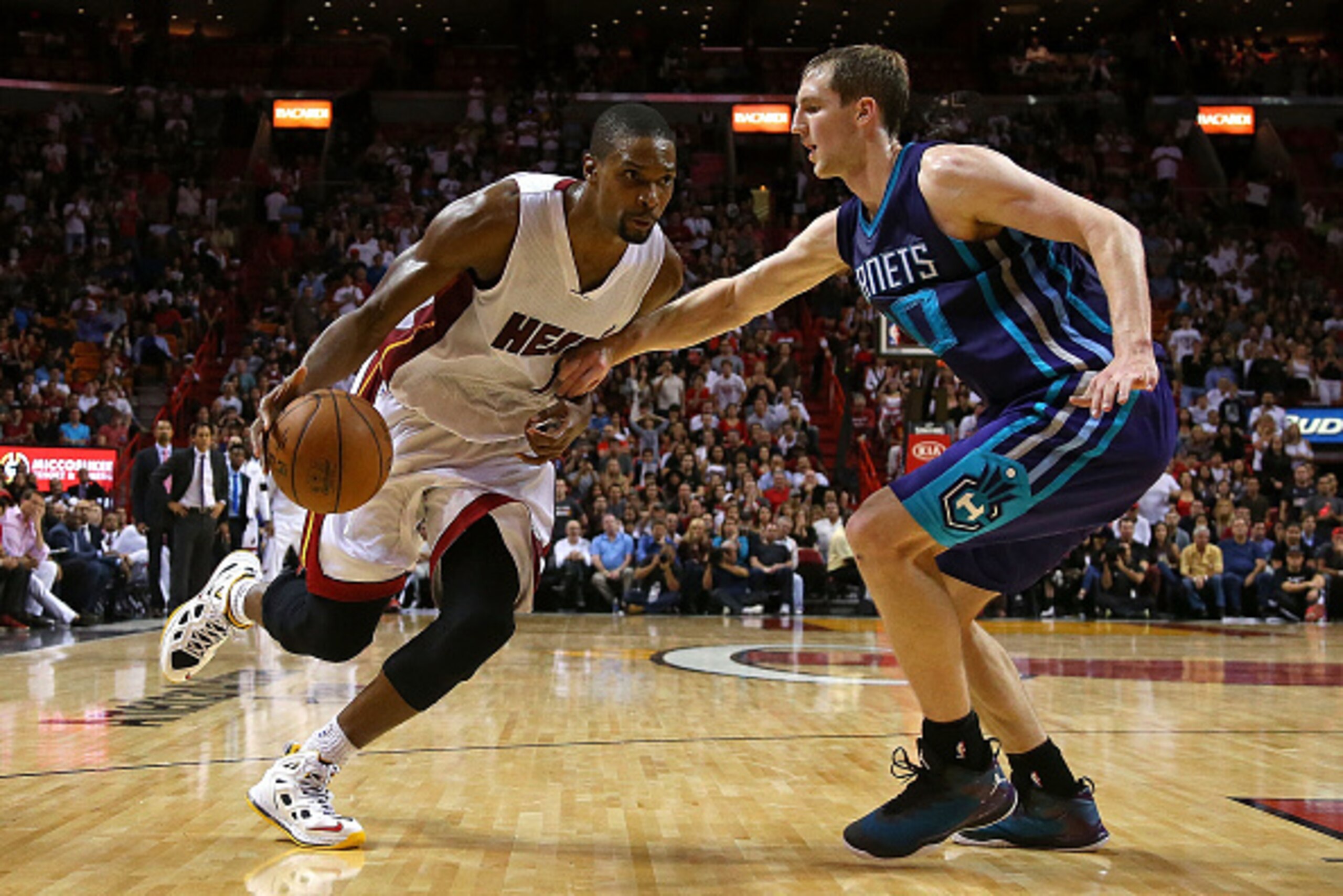 MIAMI, FL - NOVEMBER 23:  Chris Bosh #1 of the Miami Heat drives on Cody Zeller #40 of the Charlotte Hornets during a game  at American Airlines Arena on November 23, 2014 in Miami, Florida. NOTE TO USER: User expressly acknowledges and agrees that, by do