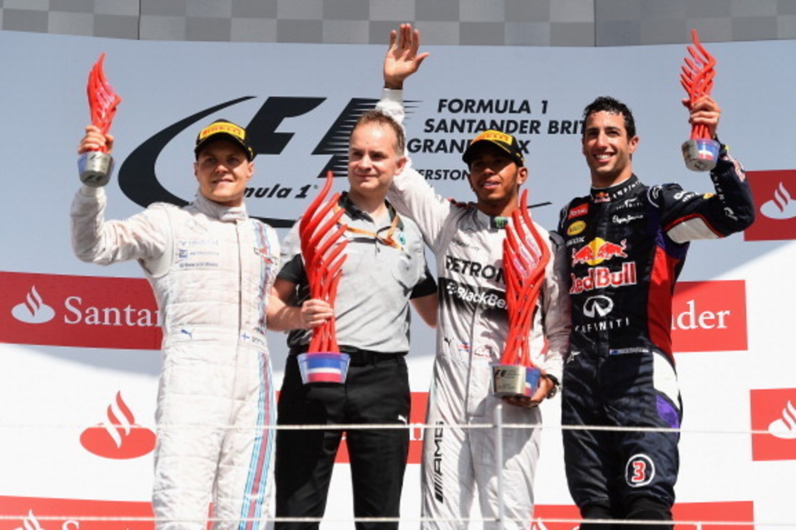 NORTHAMPTON, ENGLAND - JULY 06:  Lewis Hamilton of Great Britain and Mercedes GP celebrates on the podium next to Valtteri Bottas of Finland and Williams and Daniel Ricciardo of Australia and Infiniti Red Bull Racing after winning the British Formula One 
