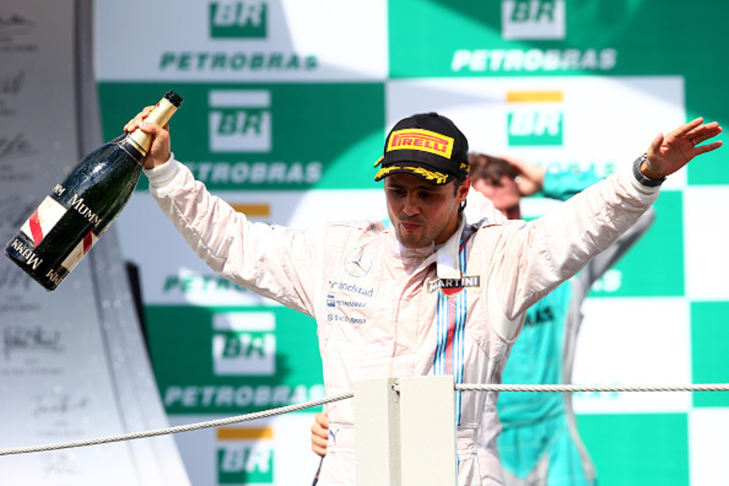 SAO PAULO, BRAZIL - NOVEMBER 09:  Felipe Massa of Brazil and Williams celebrates on the podium after finishing third in the Brazilian Formula One Grand Prix at Autodromo Jose Carlos Pace on November 9, 2014 in Sao Paulo, Brazil.  (Photo by Mark Thompson/G