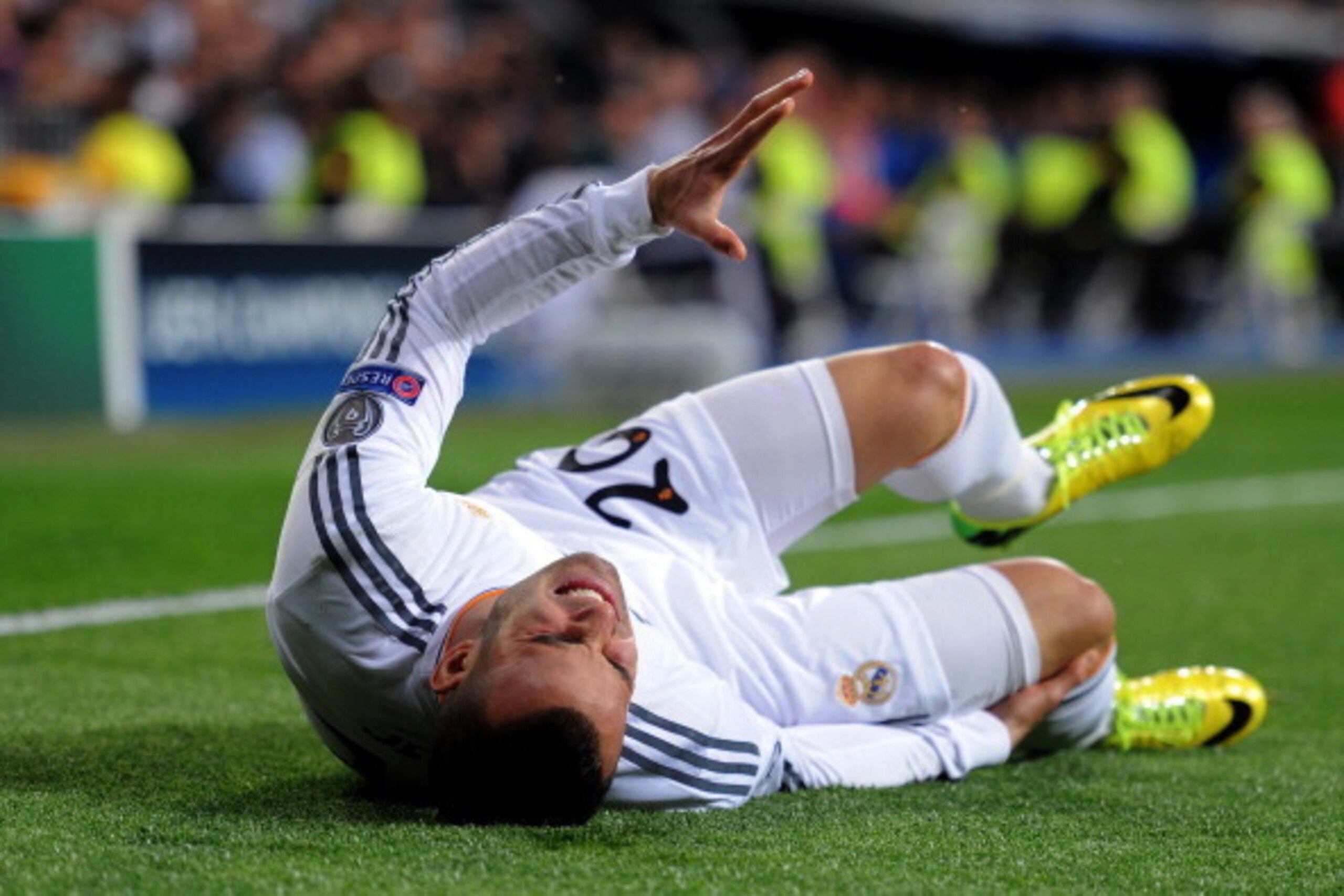 MADRID, SPAIN - MARCH 18:  Jese of Real Madrid goes down under a heavy tackle from Sead Kolasinac of Schalke during the UEFA Champions League Round of 16, second leg match between Real Madrid and FC Schalke 04 at Estadio Santiago Bernabeu on March 18, 201